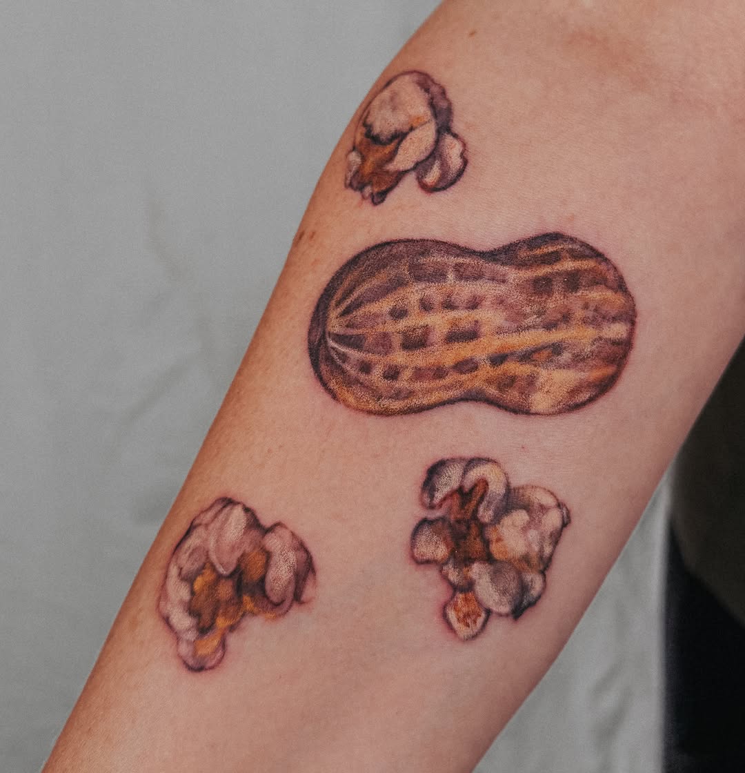 Peanut and popcorn realism tattoo on the forearm by Lucy Yin