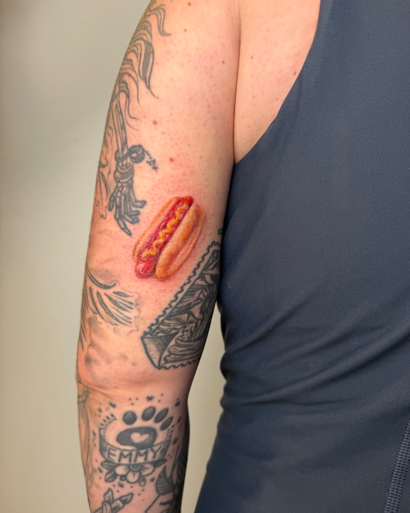 Hot dog realism tattoo on the forearm by Mackenzie