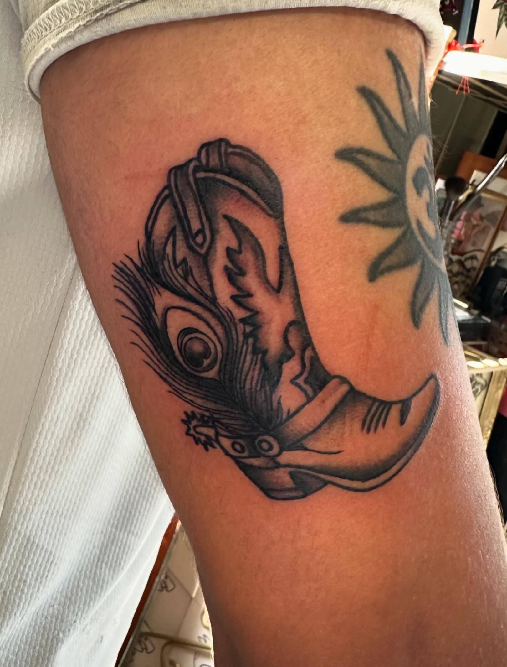 Feather and bird black and grey tattoo on the thigh by Kaylee Woods