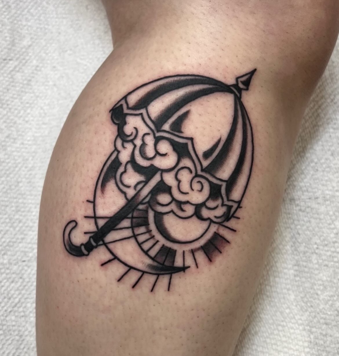 Scythe and sun black and grey tattoo on the thigh by ᴴᴬᴺᴺᴬᴴ ᴿᵁᴰᴰᴱᴸᴸ