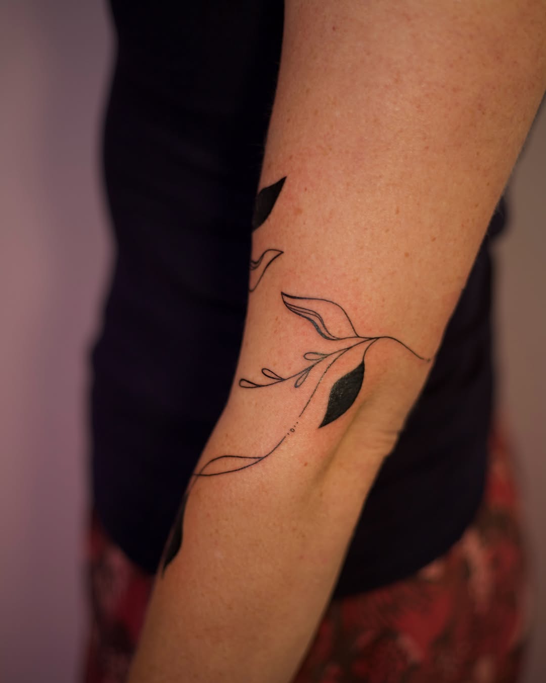Branch with leaves fine line tattoo on the forearm by Jess
