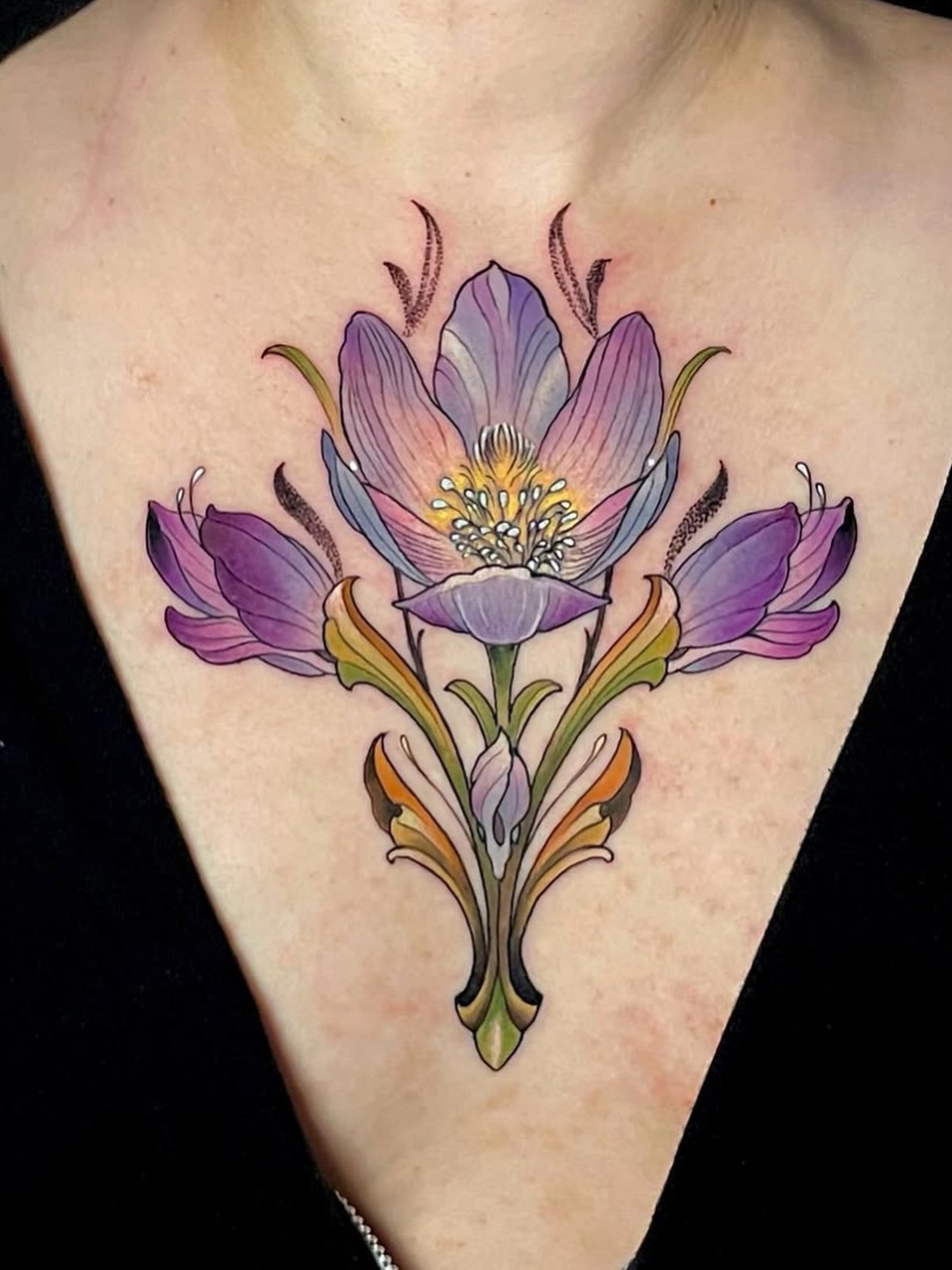 Purple flowers watercolor tattoo on the chest by Melis Fusco