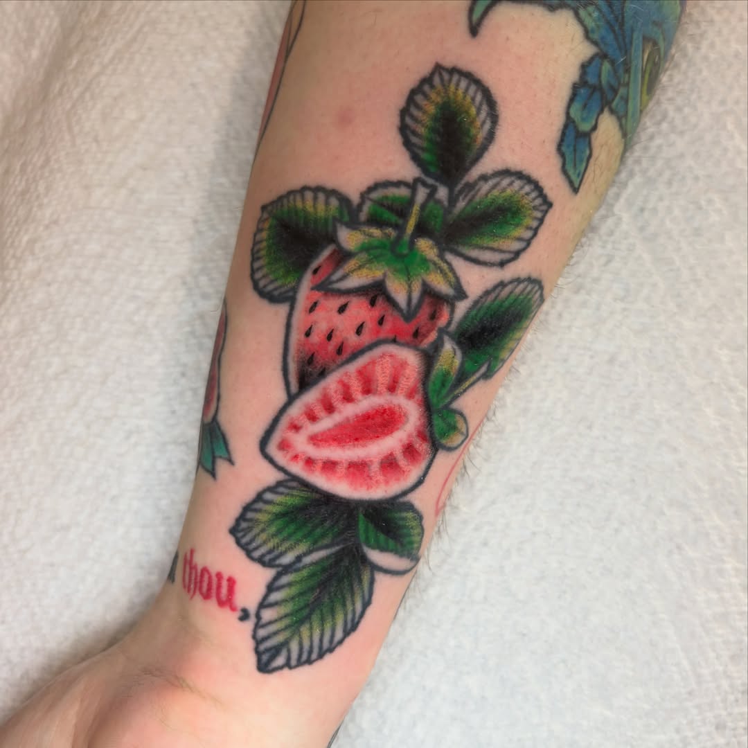 Strawberry American traditional tattoo on the forearm by Lucas Tabshey