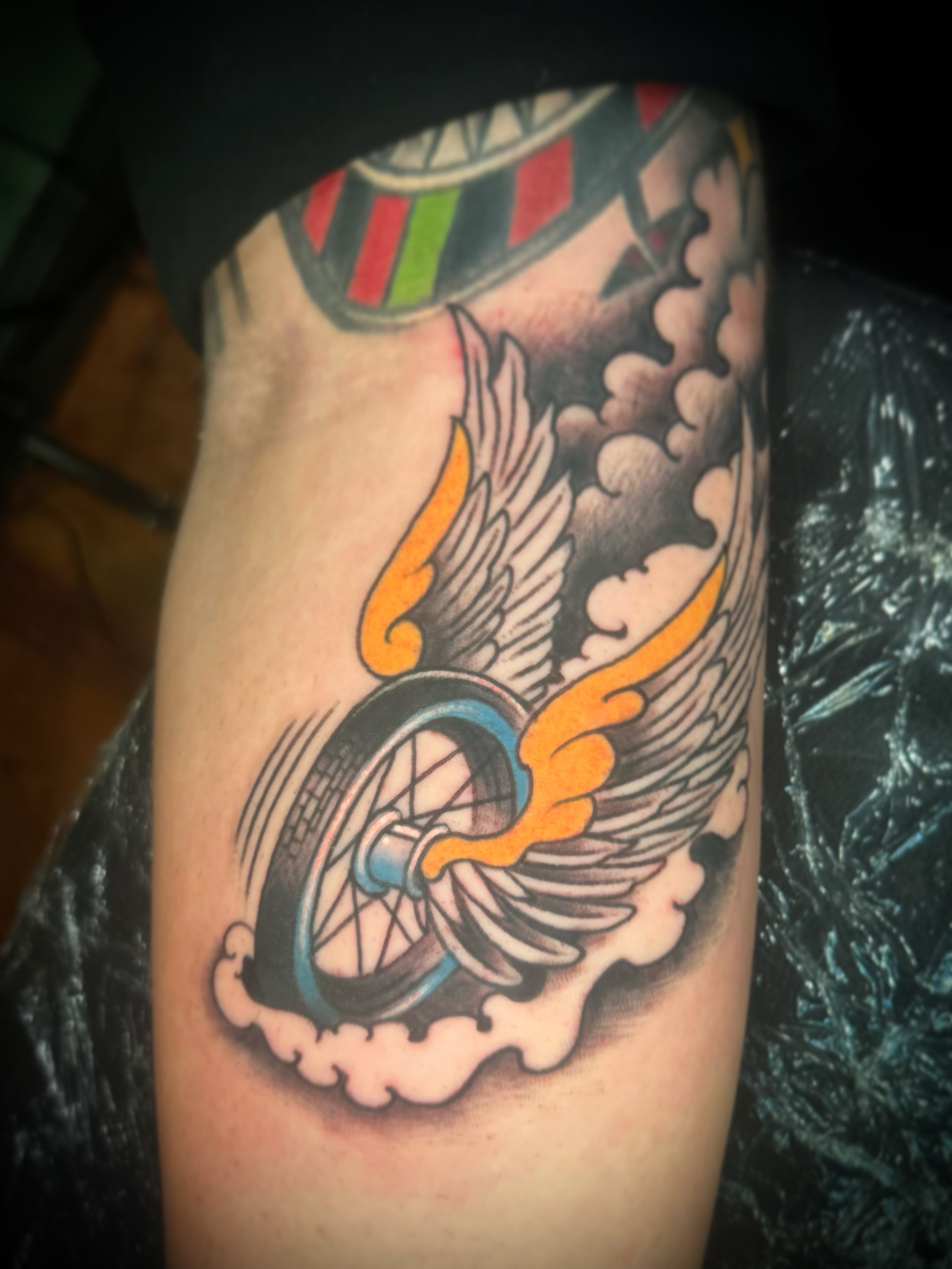 Winged tire American traditional tattoo on the forearm by Daemion