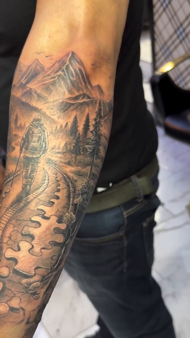 Mountain landscape with train tracks surrealism tattoo on the forearm by Jose Onasis Disla, New York, New York