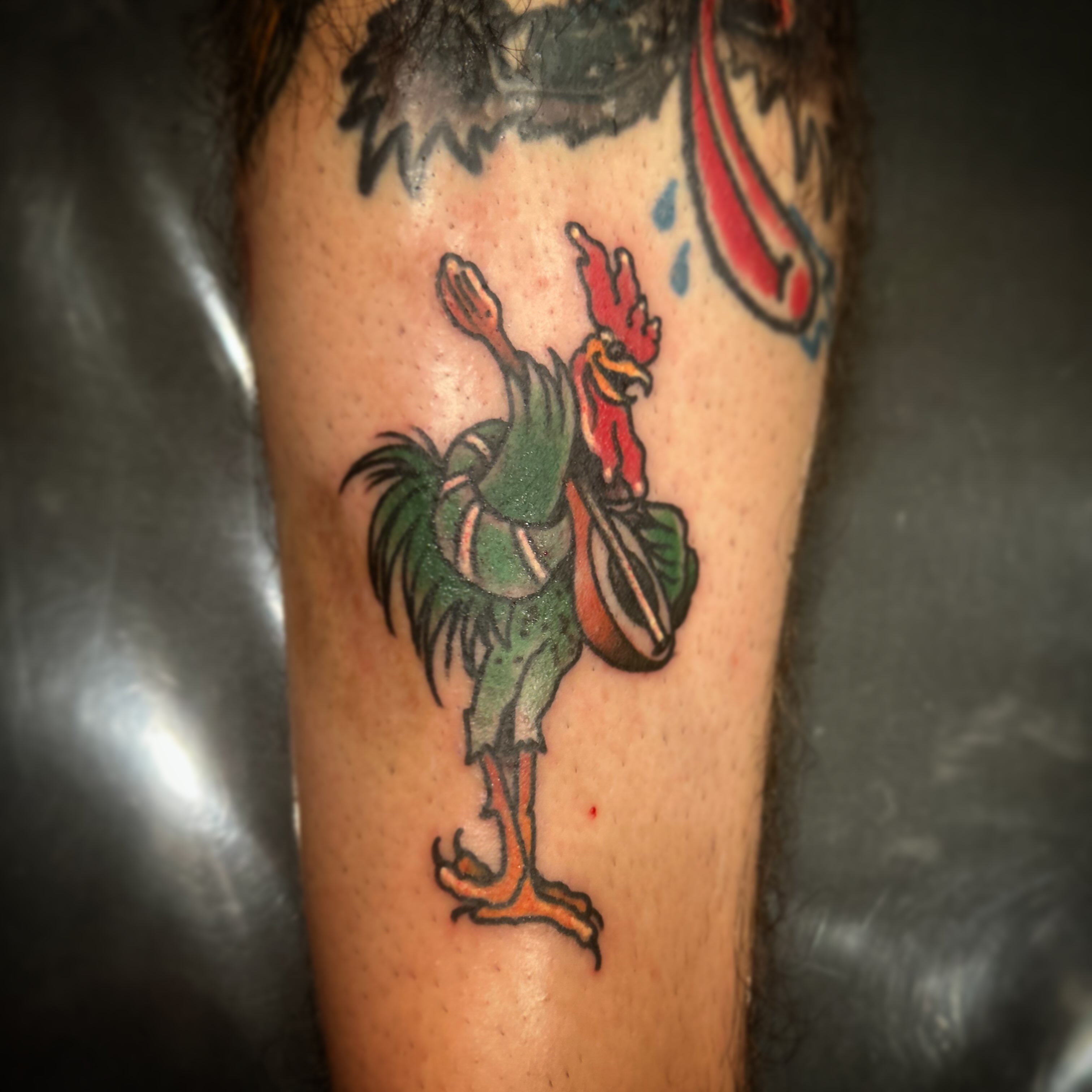 Rooster American traditional tattoo on the forearm by Daemion
