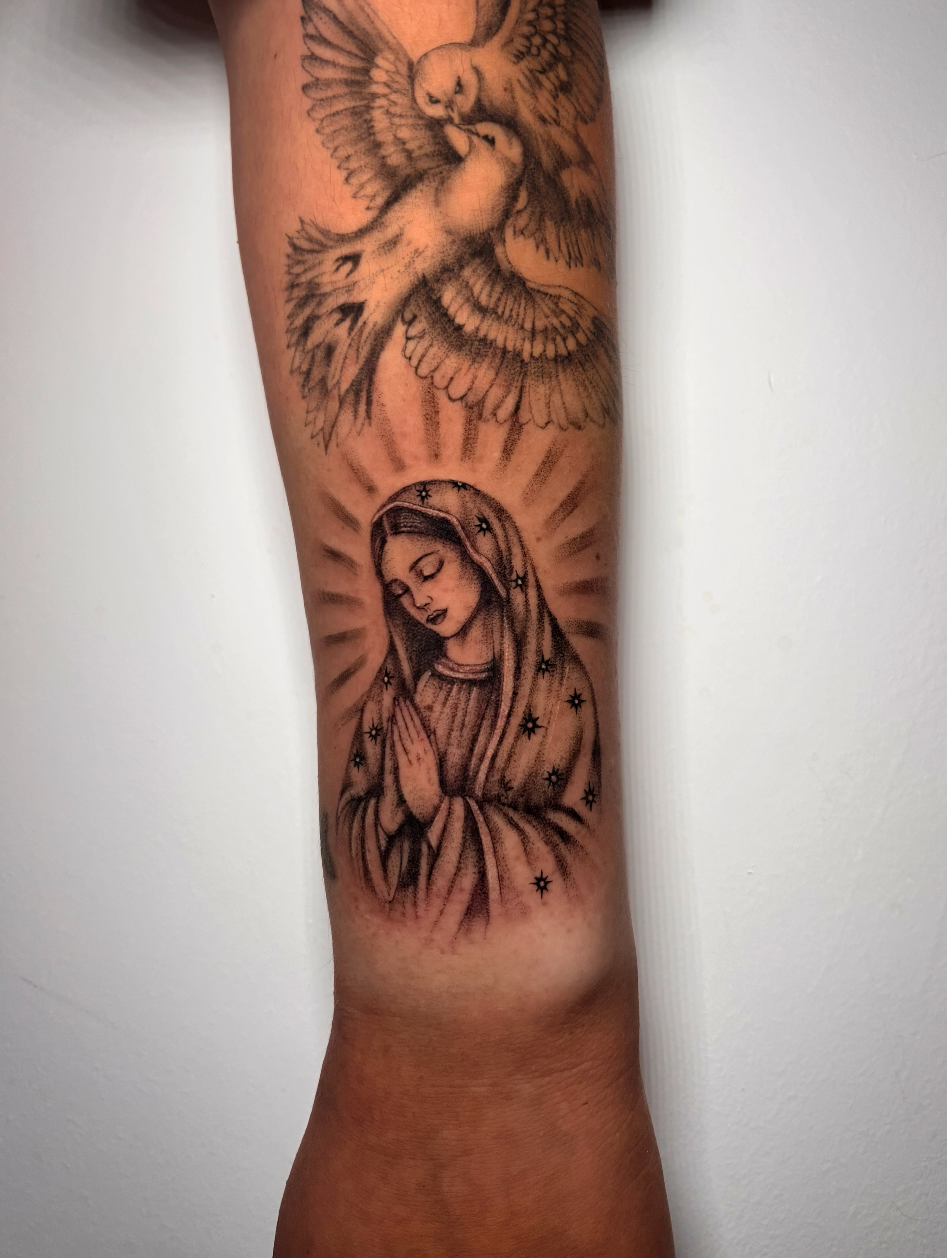 Religious figure with doves black and grey tattoo on the forearm by l i z ✶