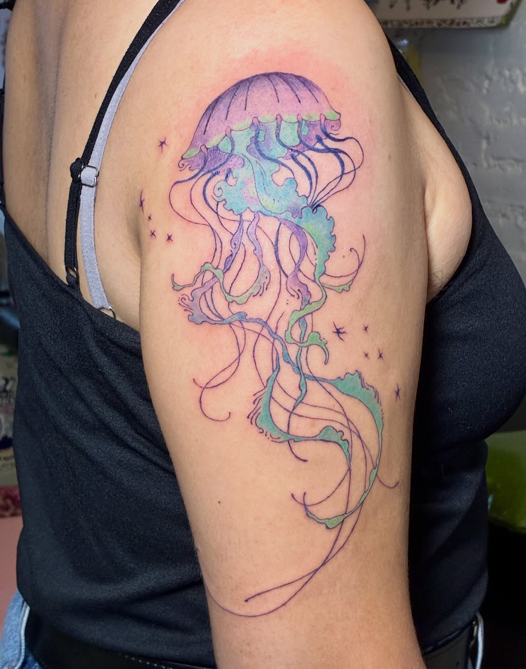 Jellyfish watercolor tattoo on the shoulder by thalia