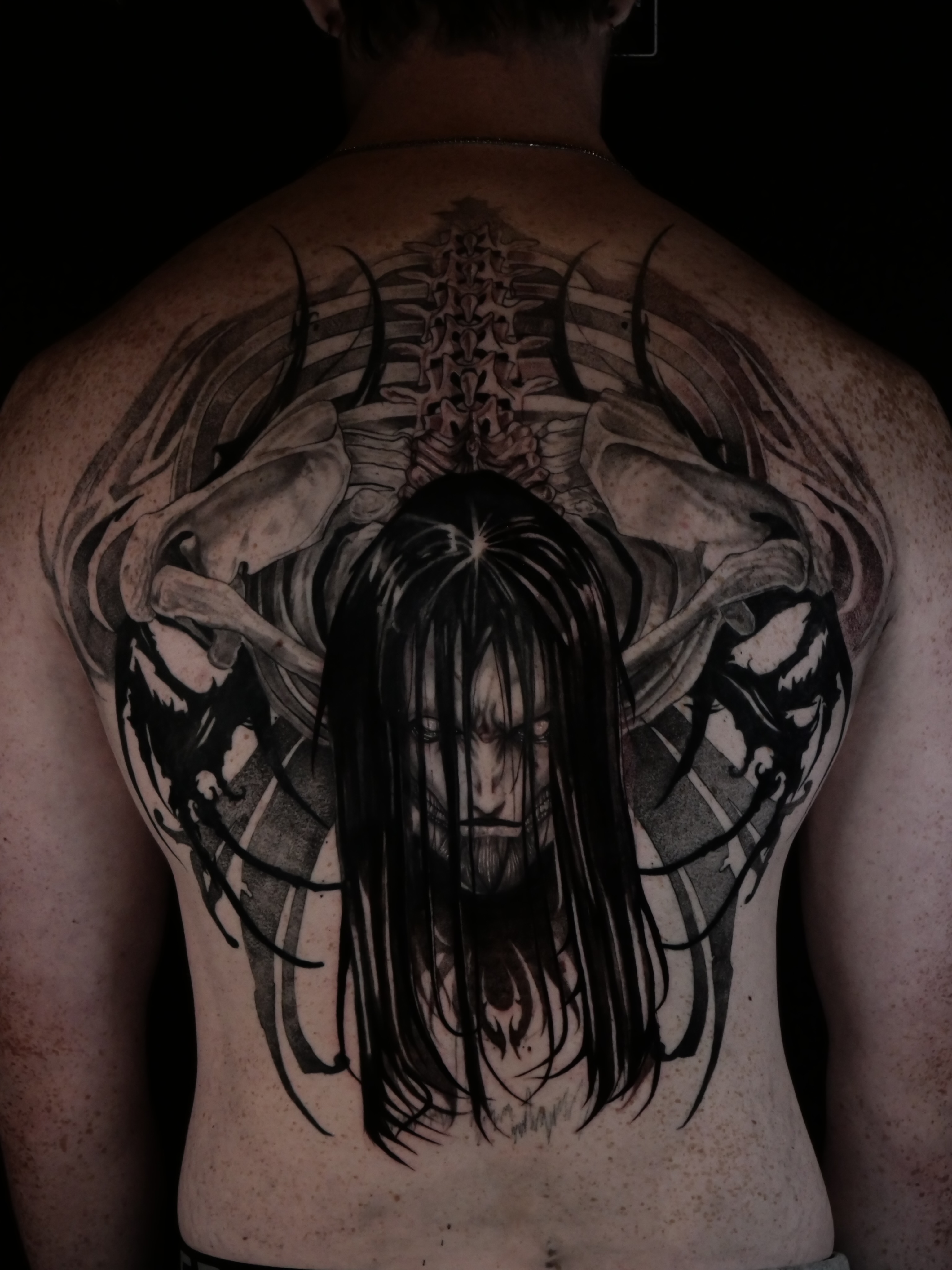 Woman with long hair realism tattoo on the back by Sloppy