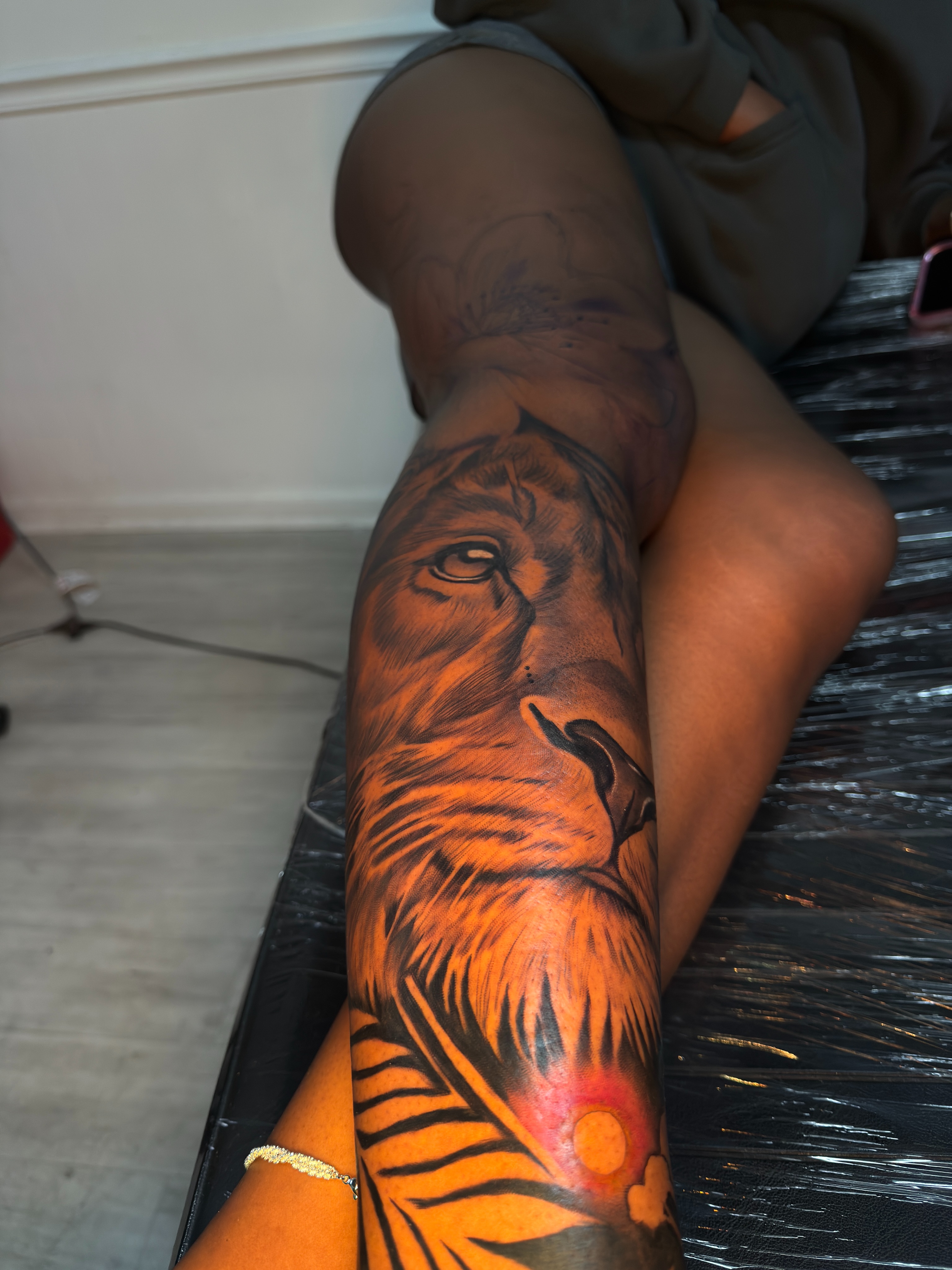 Lion realism tattoo on the leg by Savannah Tattoo Artist