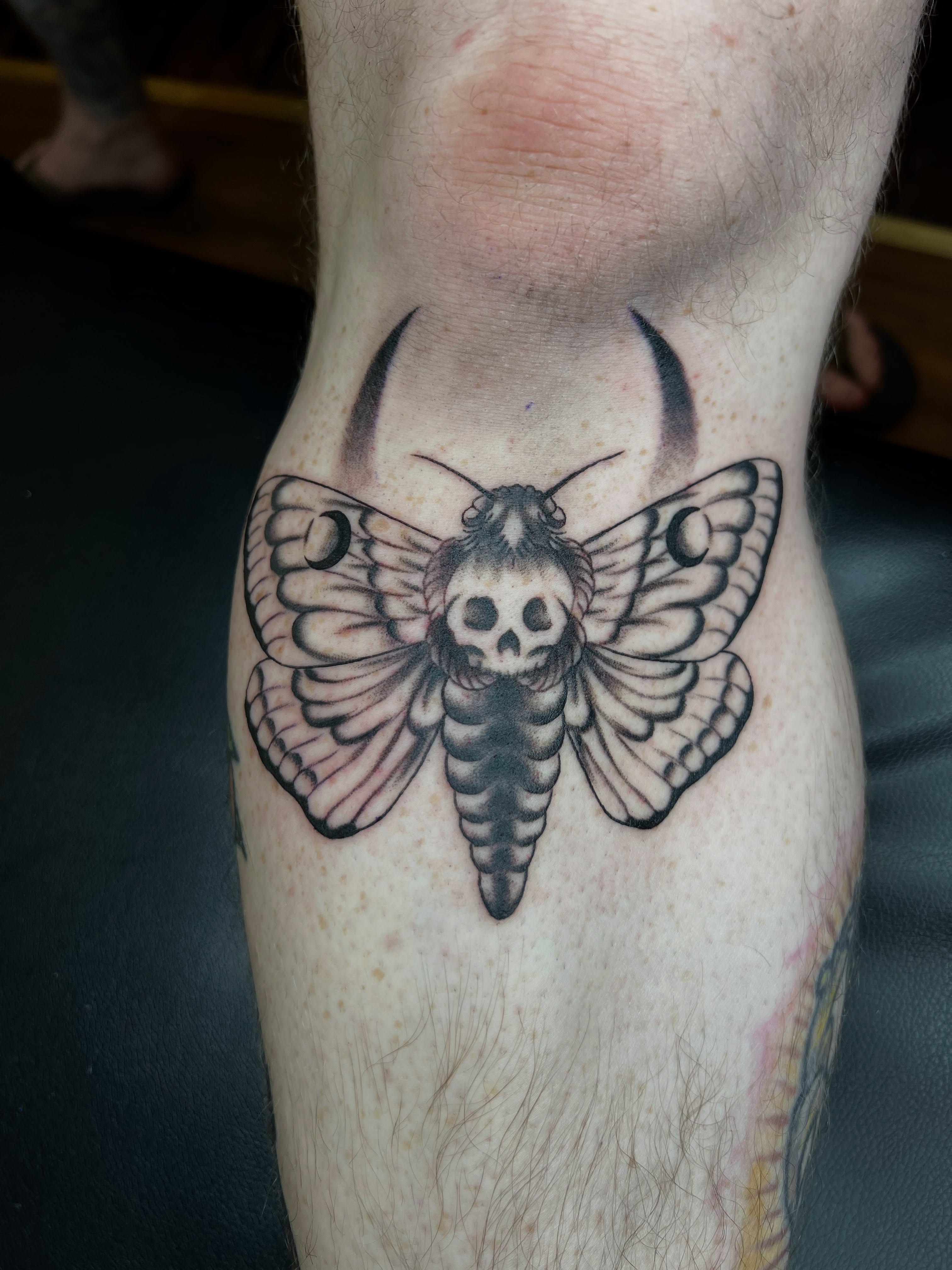 Death's-head hawkmoth black and grey tattoo on the thigh by Cory Miller