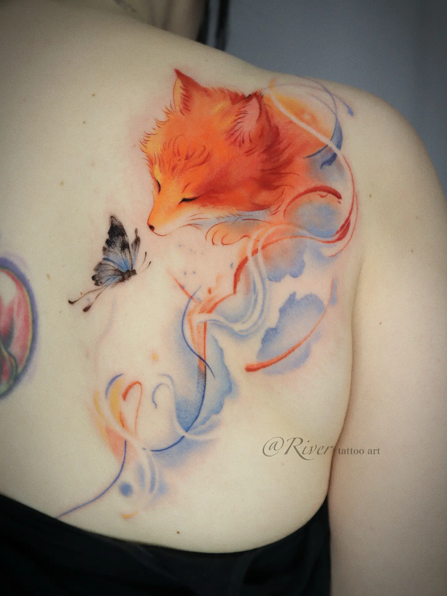 Fox and butterfly watercolor tattoo on the shoulder by River