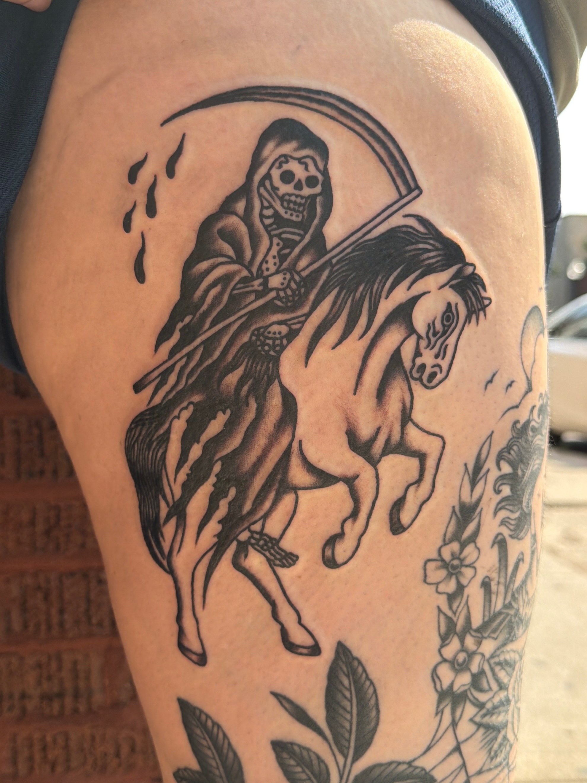 Grim reaper on horse black and grey tattoo on the thigh by Emma Fox Tattoo