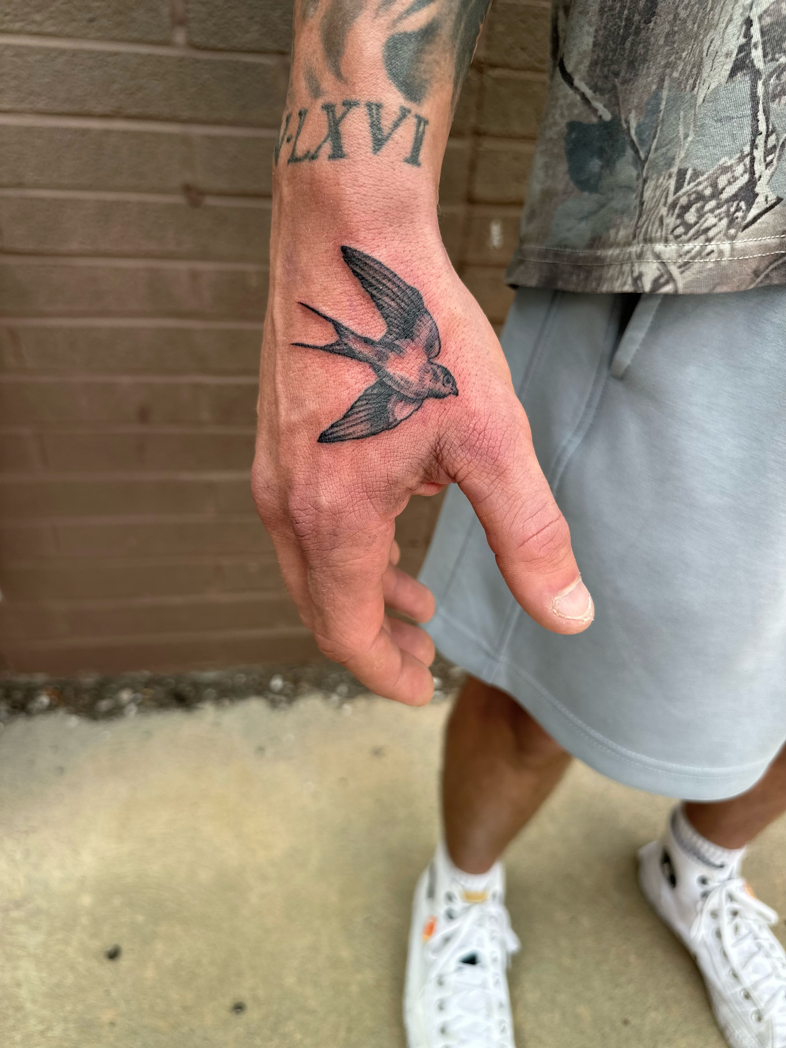 Swallow realism tattoo on the hand by Jesse White, Mentor, Ohio