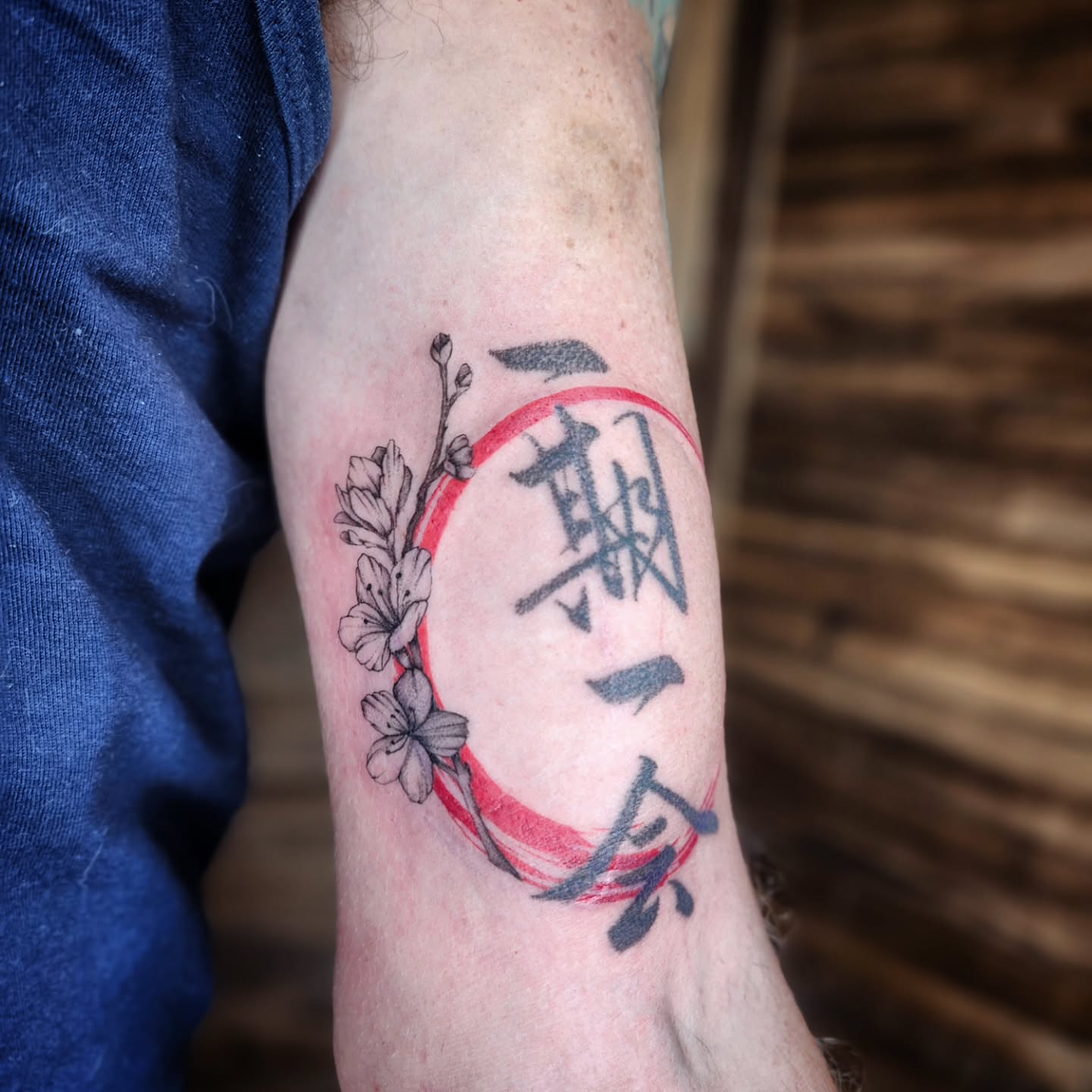 Cherry blossoms and kanji japanese irezumi tattoo on the forearm by Kelly Zito