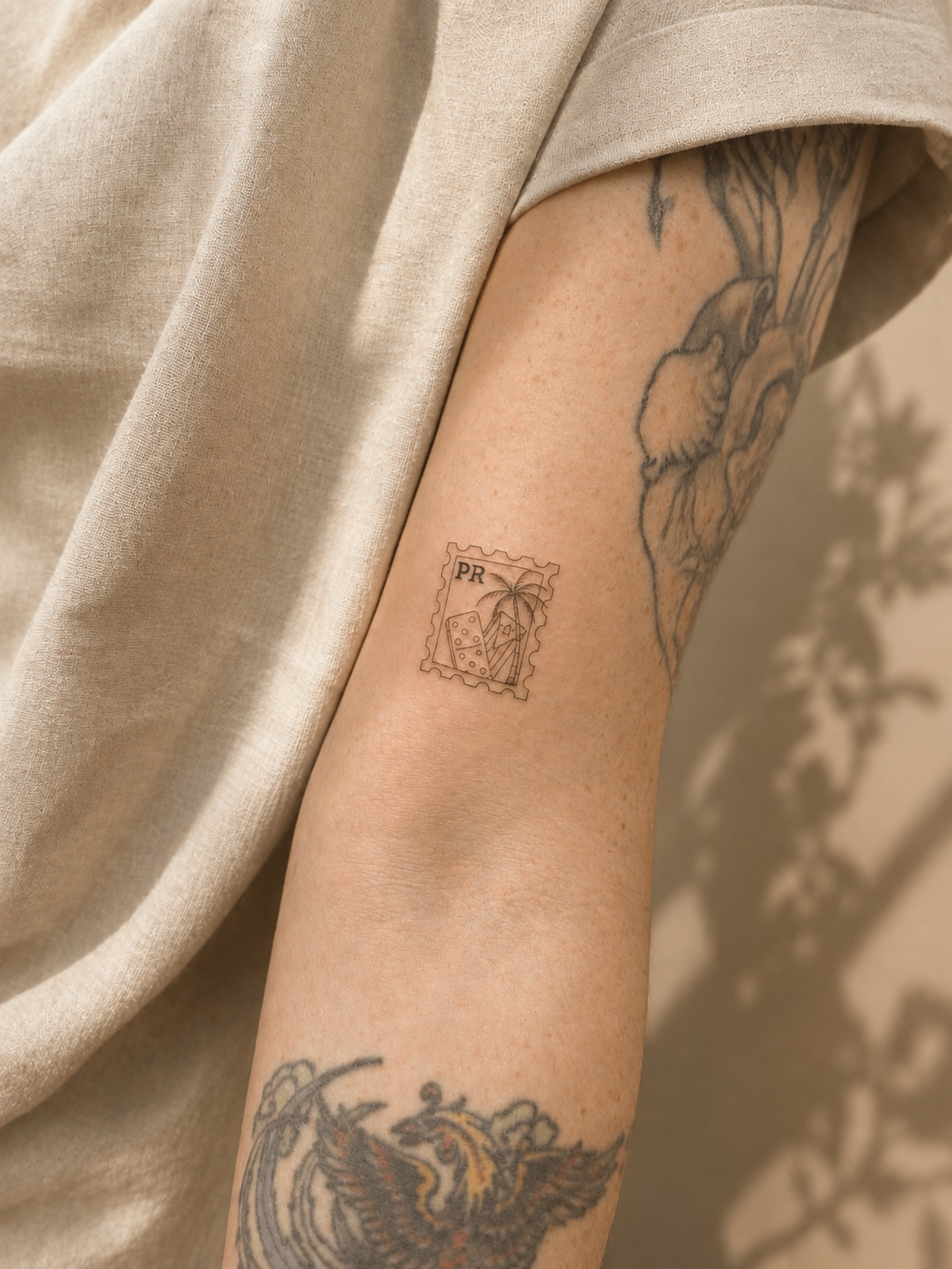 Postage stamp black and grey tattoo on the forearm by Takyro
