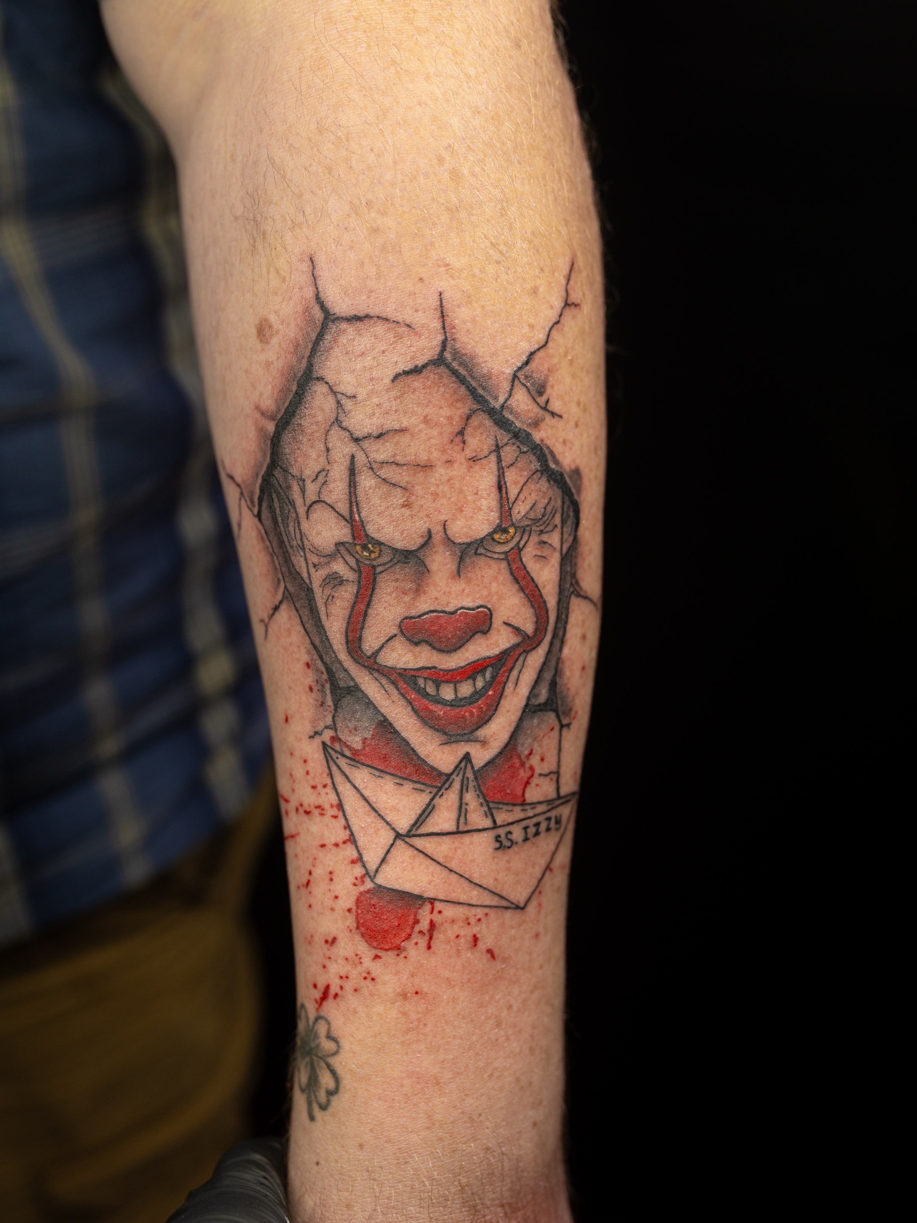Clown with paper boat realism tattoo on the forearm by Kelsie
