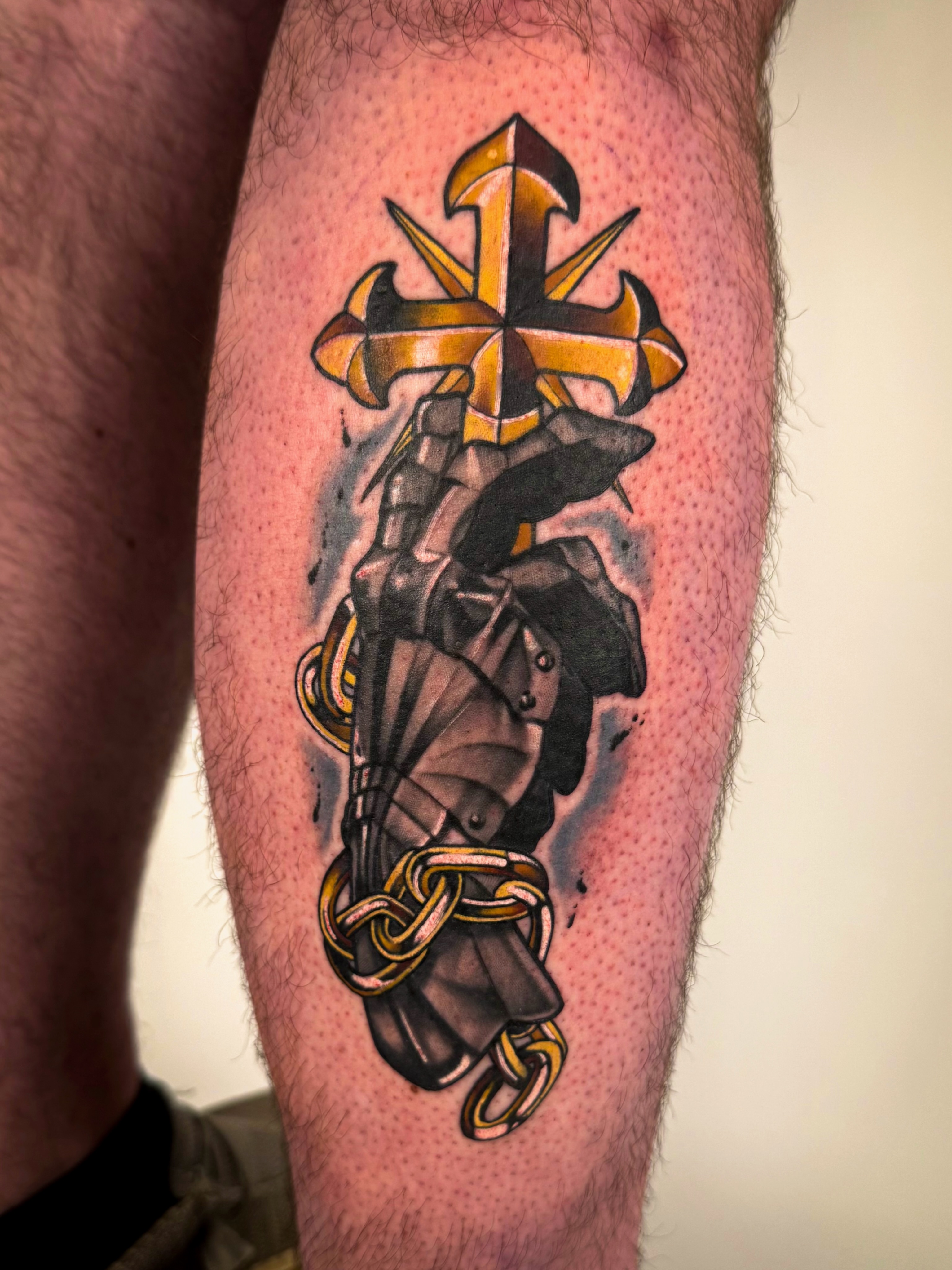 Cross and armor neo-traditional tattoo on the leg by Sam Babcock