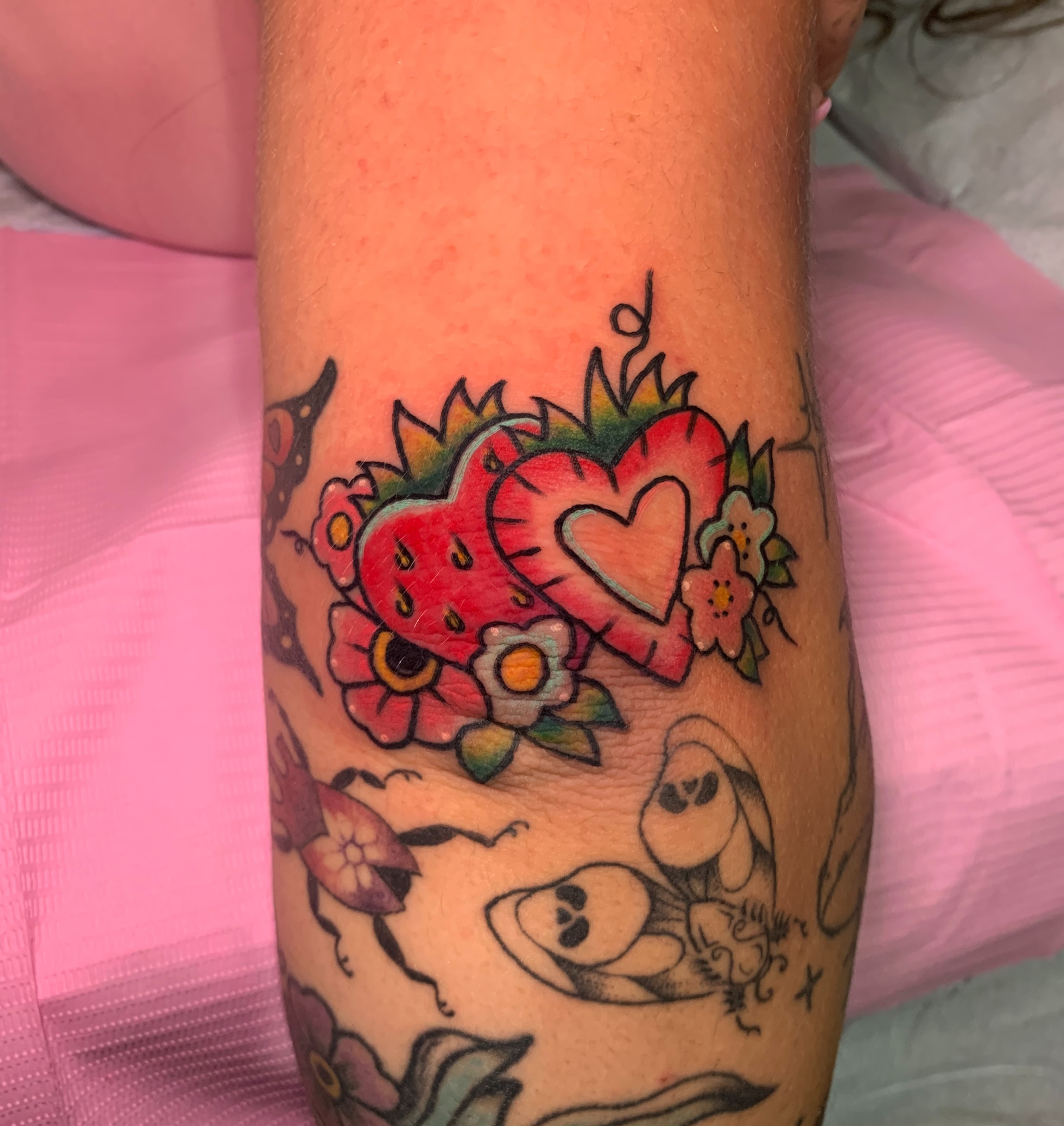 Strawberries and flowers American traditional tattoo on the forearm by Aubrianna Grisez
