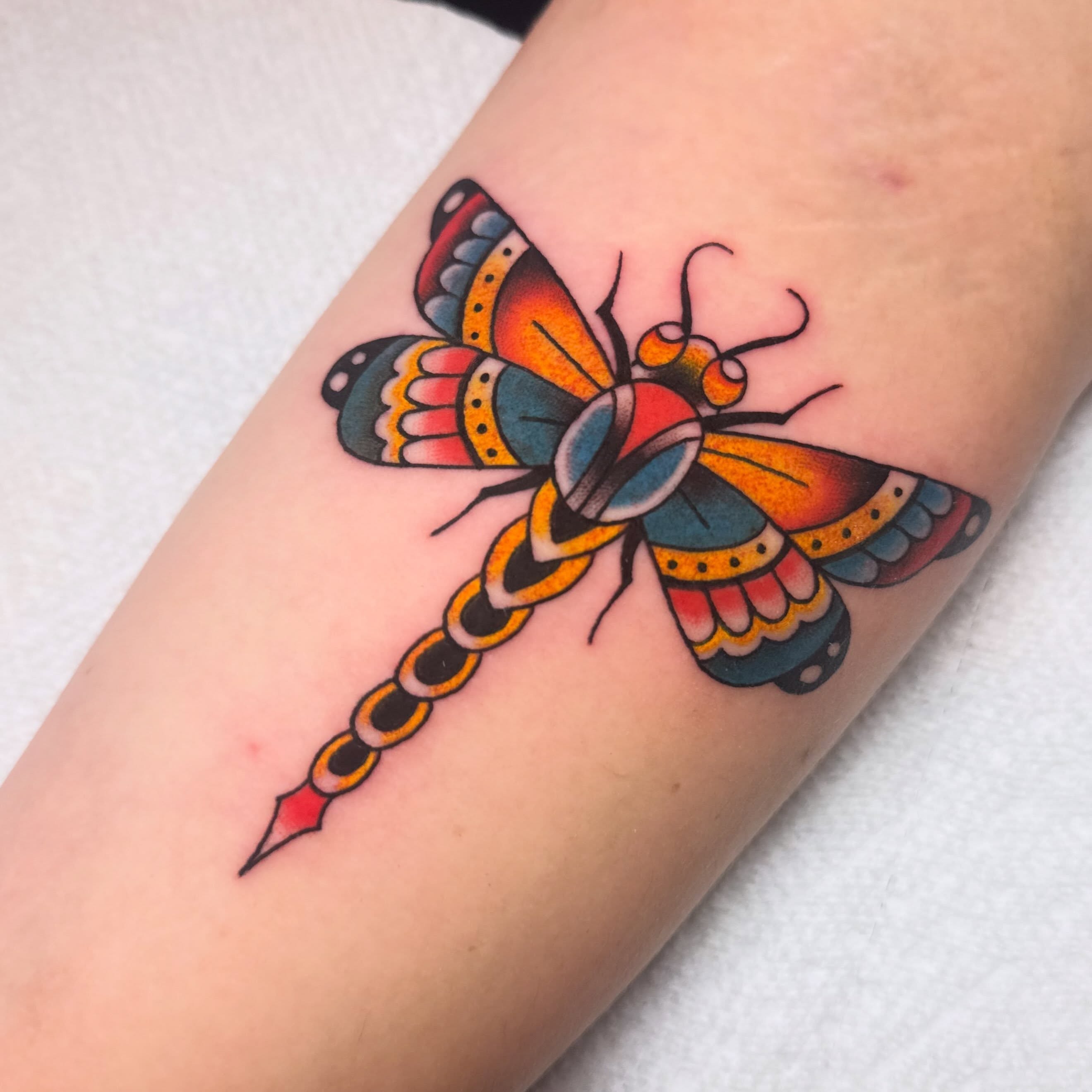Dragonfly American traditional tattoo on the forearm by Shelby