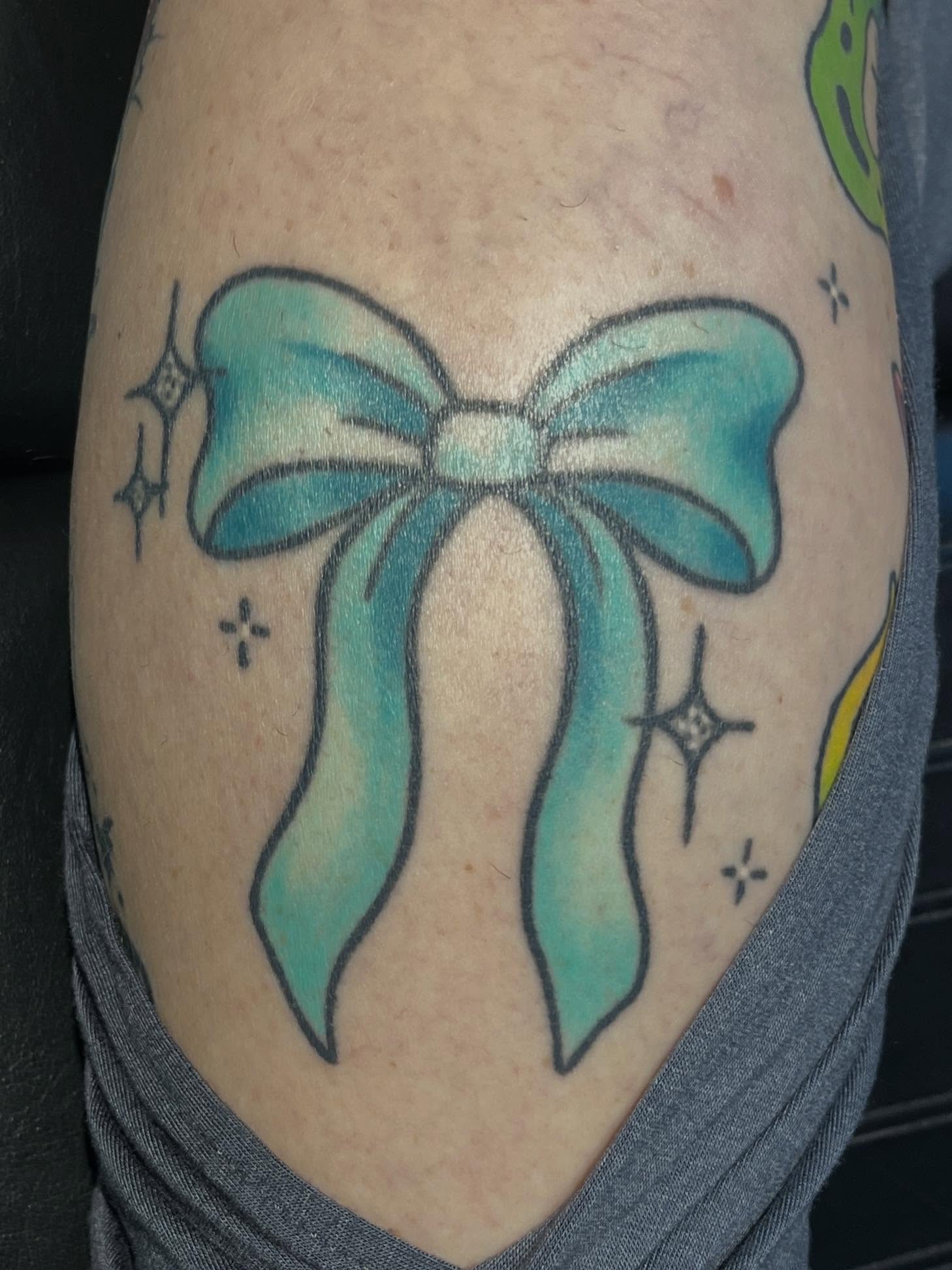Bow new school tattoo on the thigh by 🖤Jess Pereira🖤, Framingham, Massachusetts