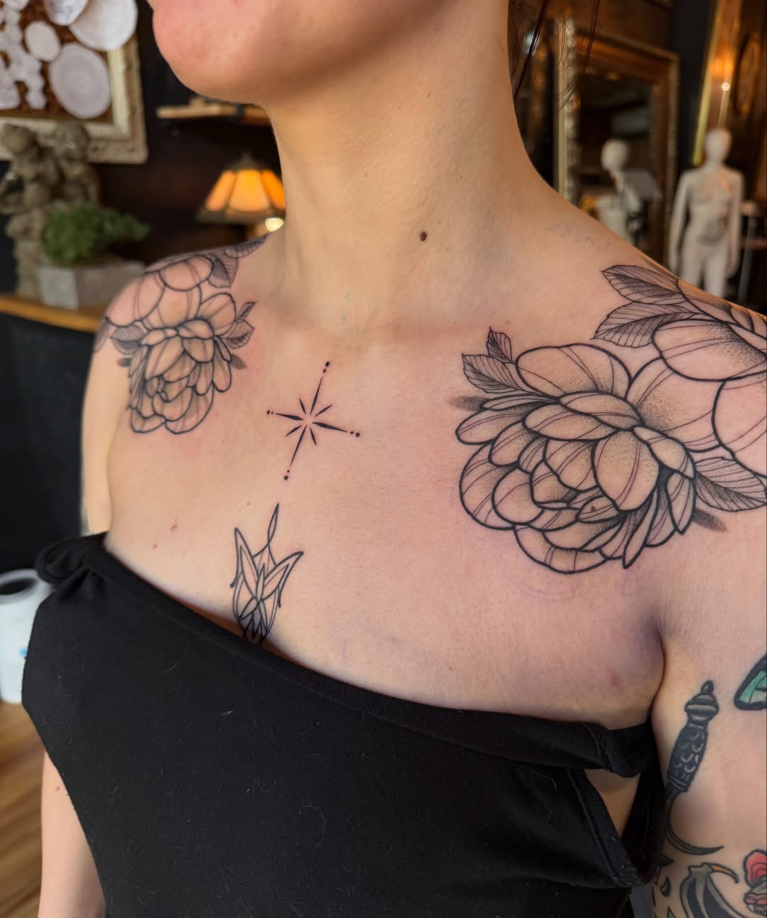 Floral black and grey tattoo on the chest by Allison