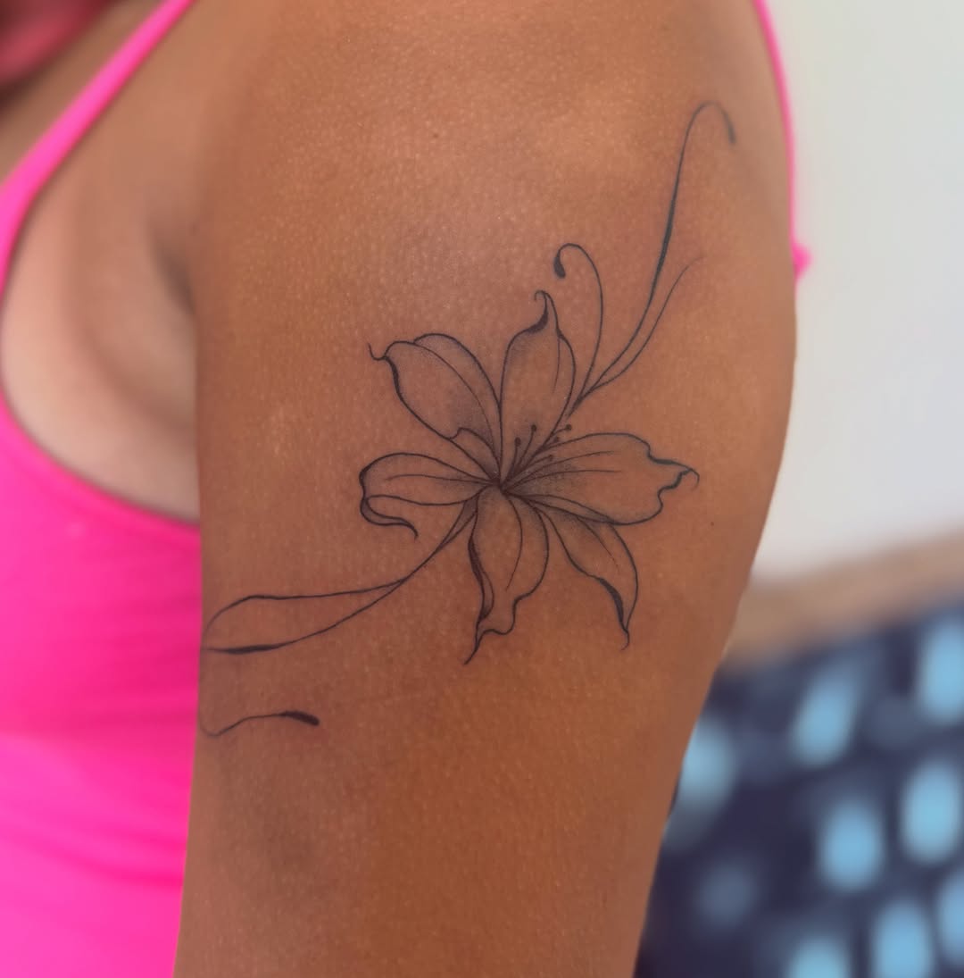 Lily black and grey tattoo on the upper arm by savannah