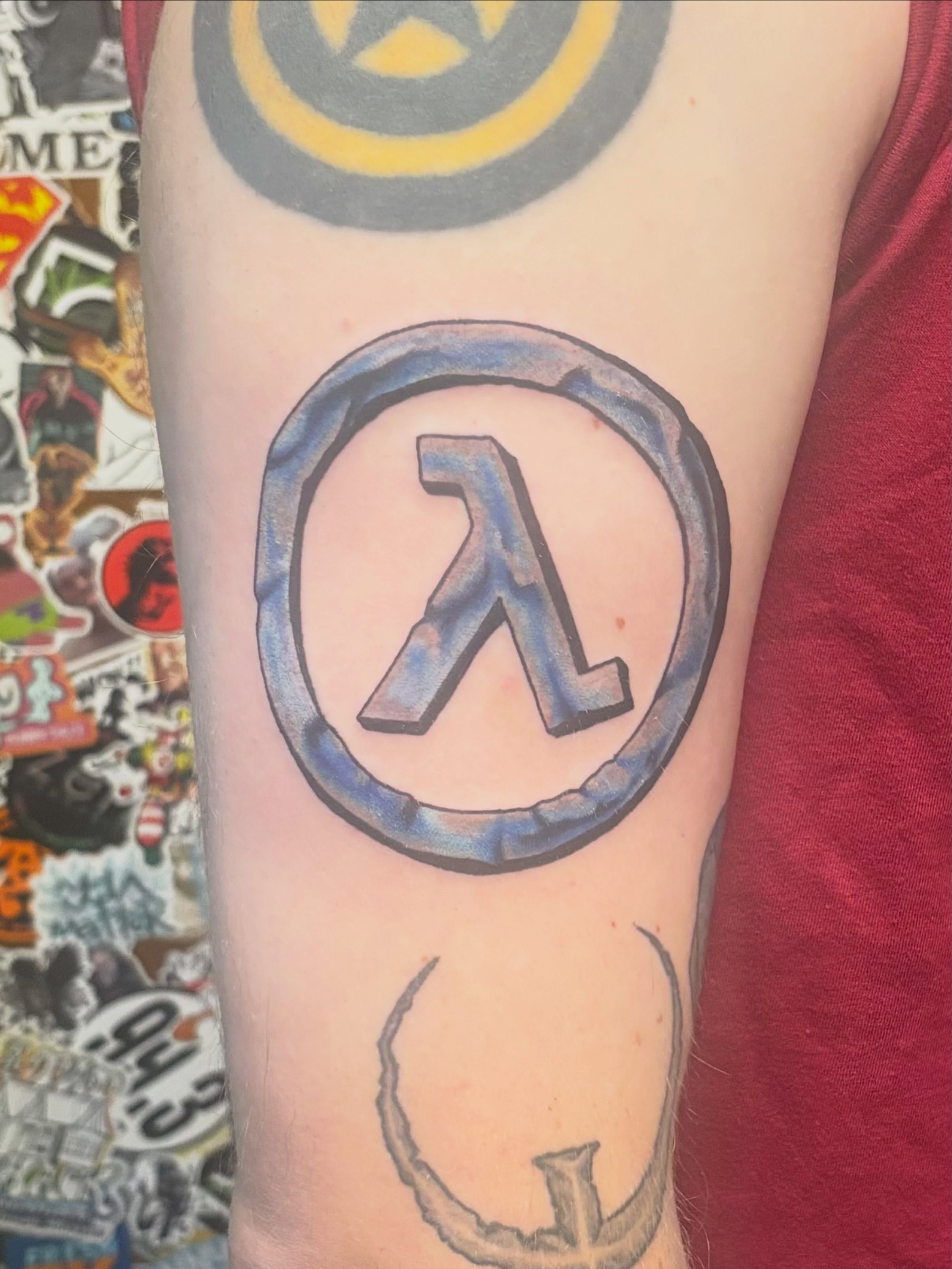 Half-Life Lambda symbol geometric tattoo on the forearm by Jeff Zuptich