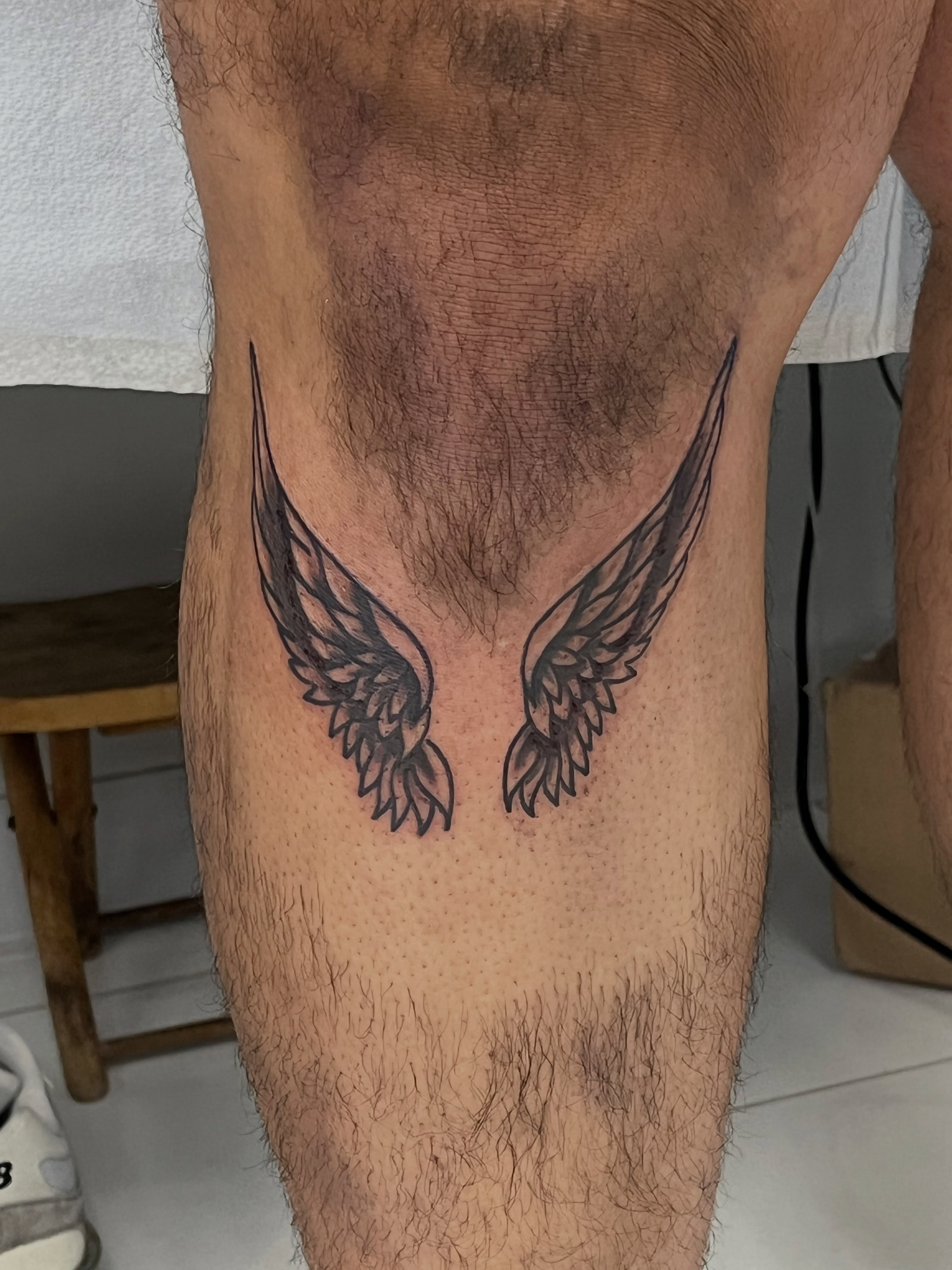 Wings black and grey tattoo on the thigh by Sour Tattoo, Somerville, Massachusetts