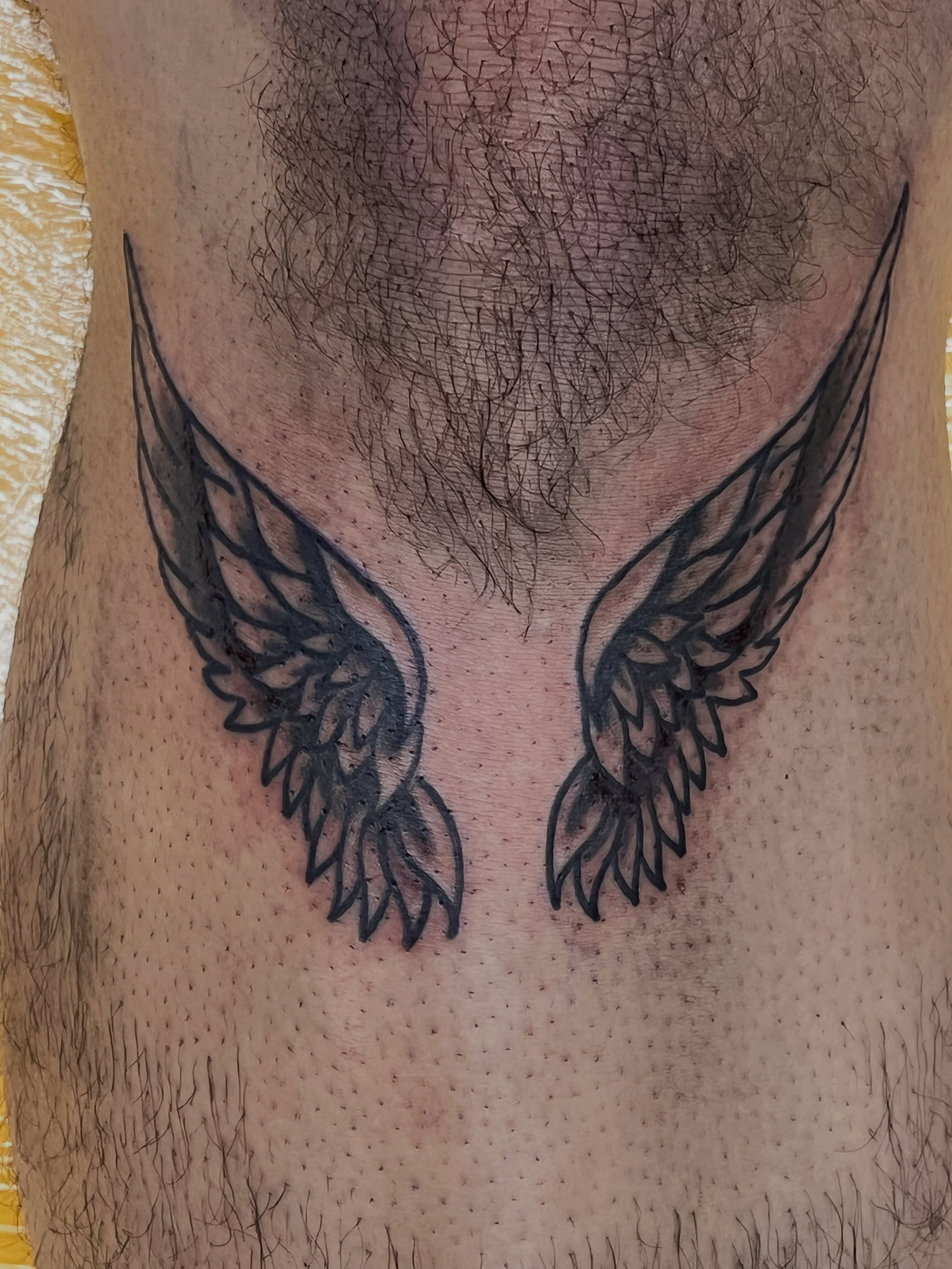 Wings black and grey tattoo on the thigh by Sour Tattoo, Somerville, Massachusetts