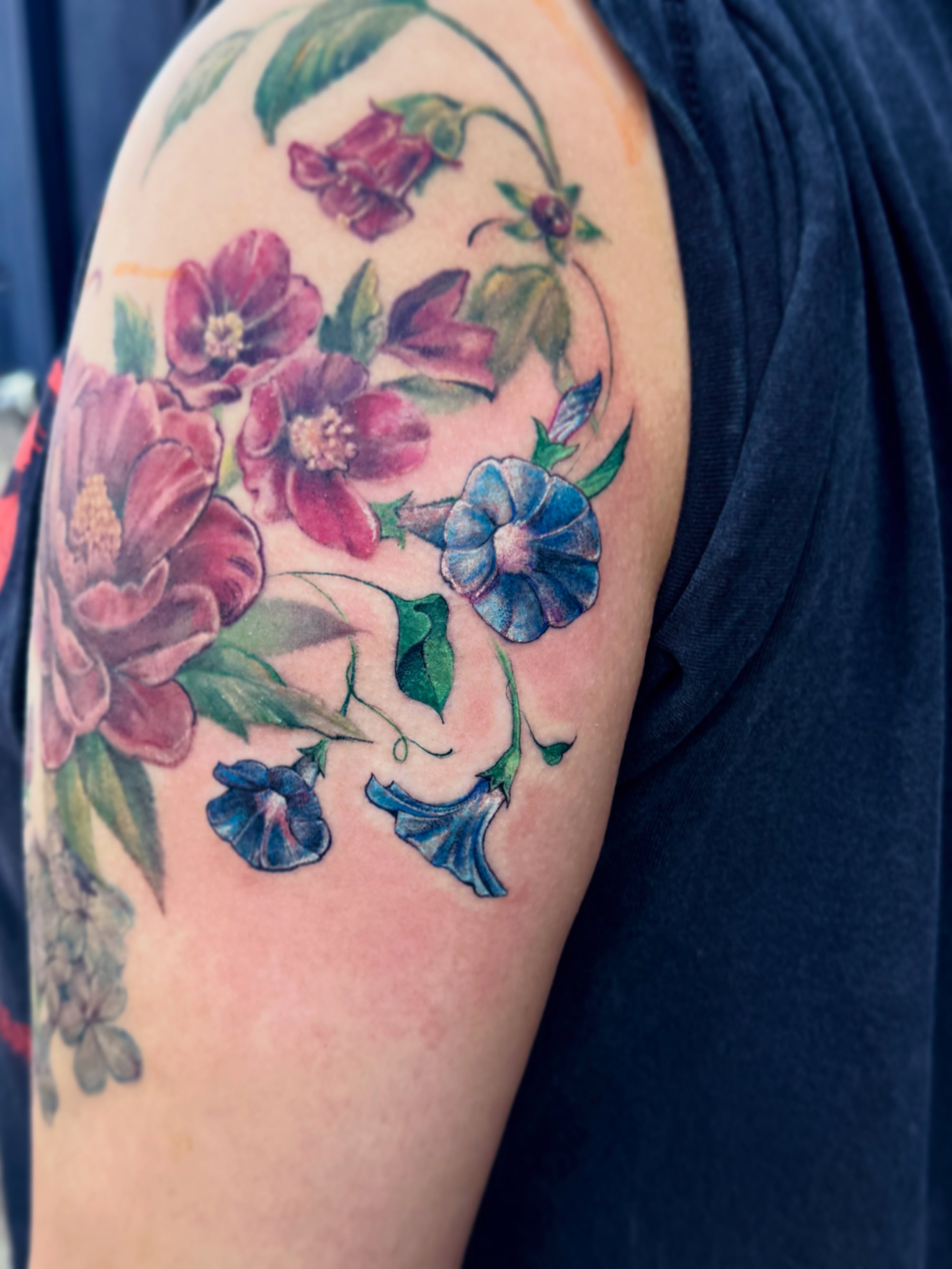 Flowers watercolor tattoo on the shoulder by Andy Rowe- Tattoo Artist🦇