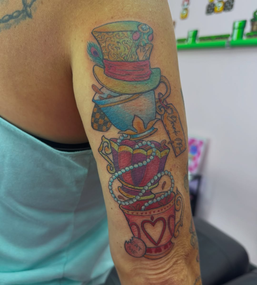Alice in wonderland tea party new school tattoo on the forearm by Jada Reynolds