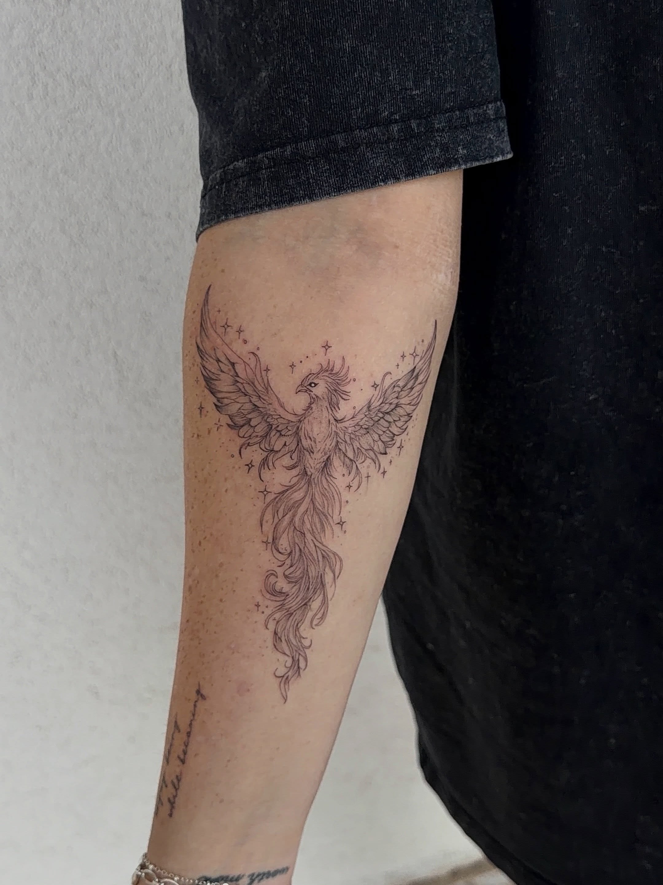 Phoenix black and grey tattoo on the forearm by Jacksyn, Plano, Texas