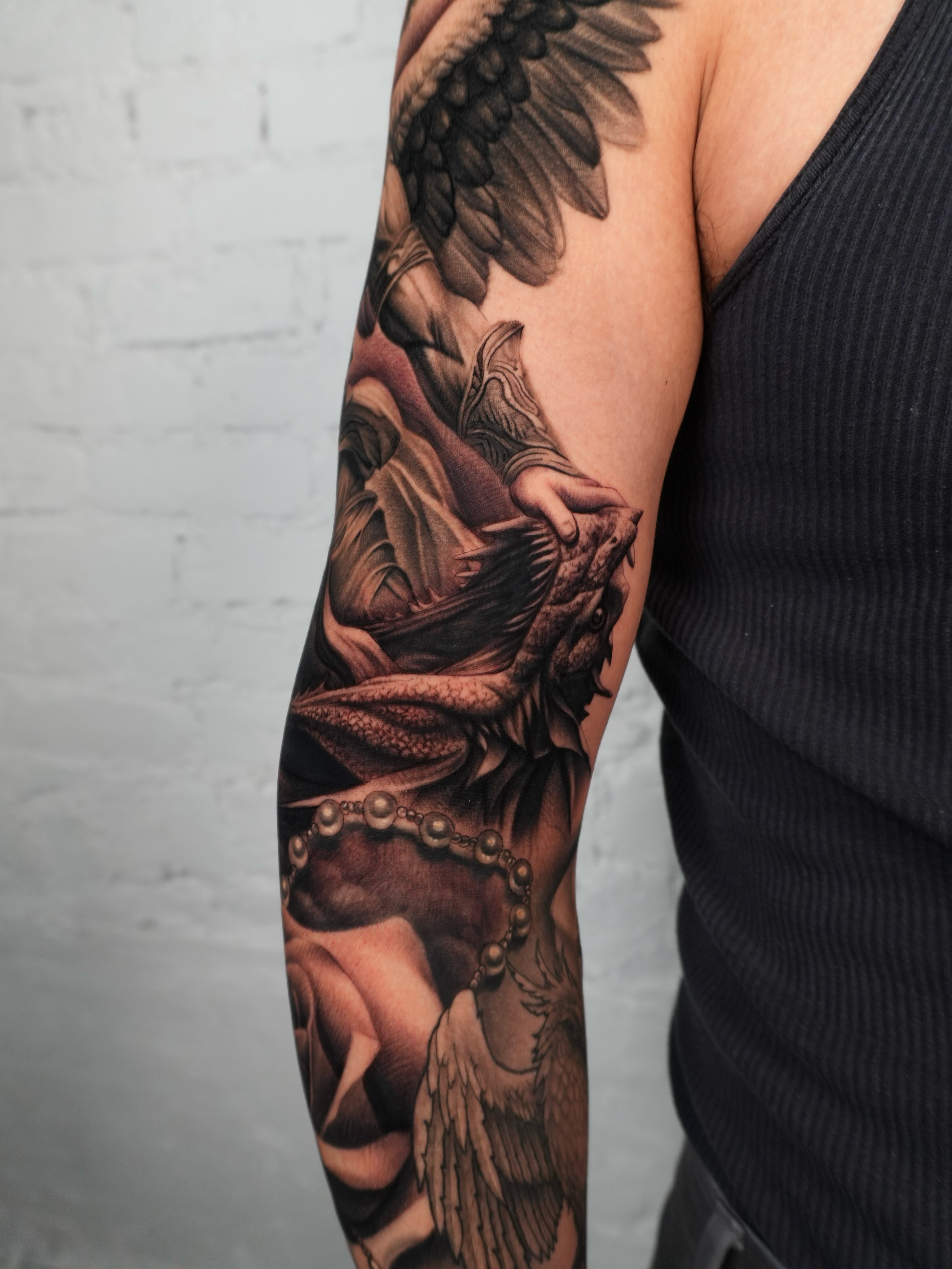 Dragon and pearl necklace realism tattoo on the forearm by Reena Pho, Nashville, Tennessee