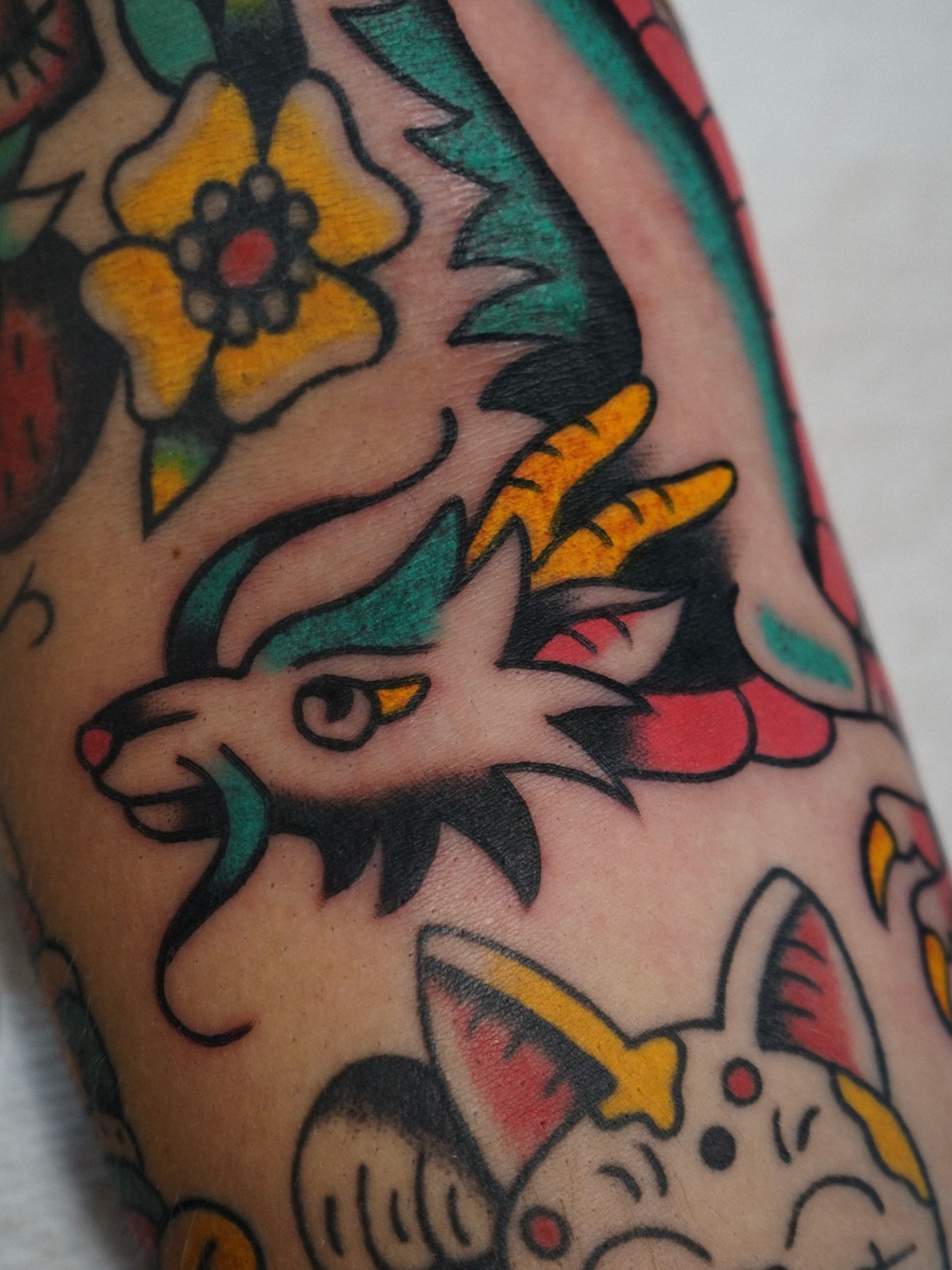 Deer and cat American traditional tattoo on the forearm by Emily Devenz
