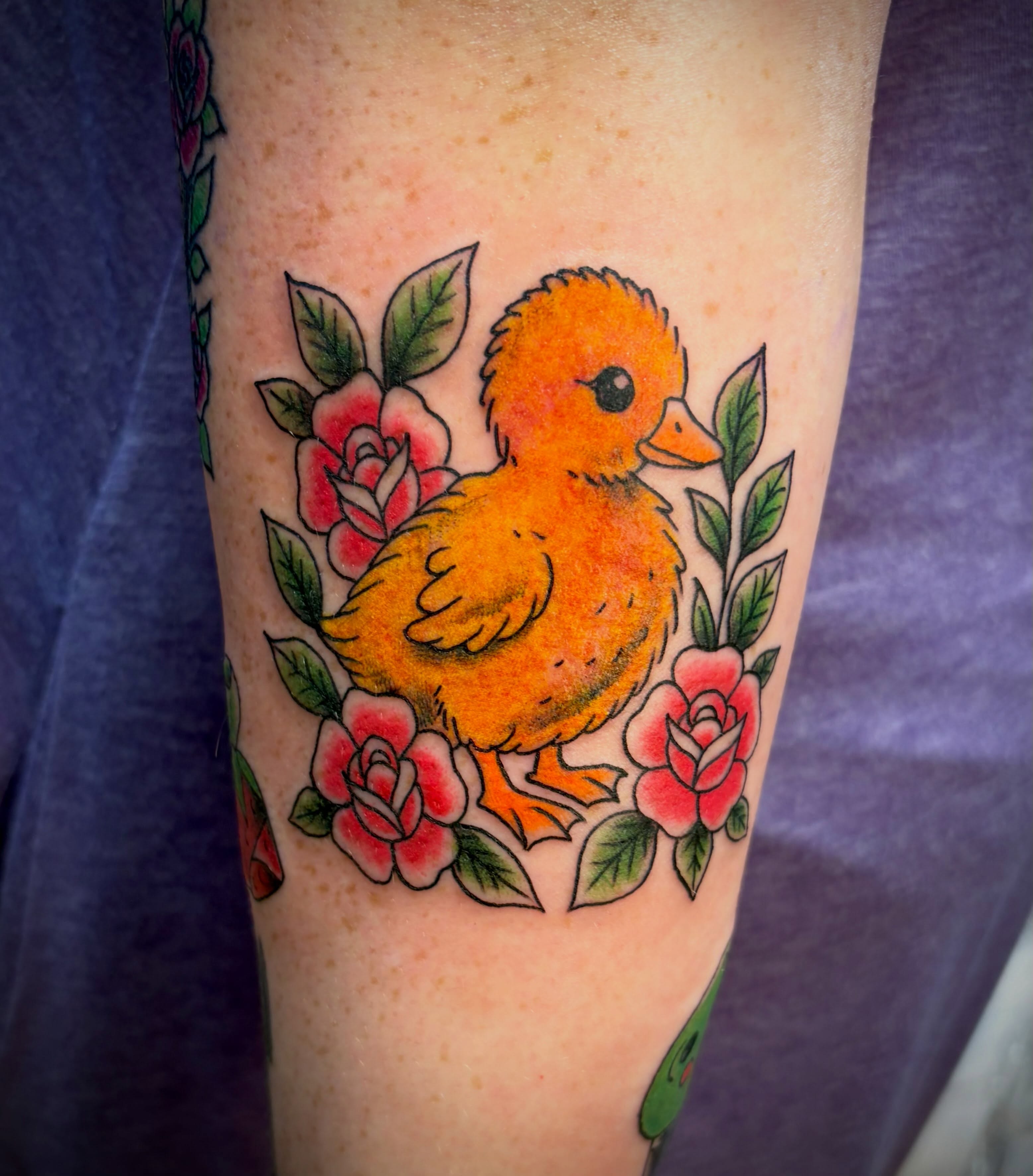 Chick and roses American traditional tattoo on the forearm by Reid