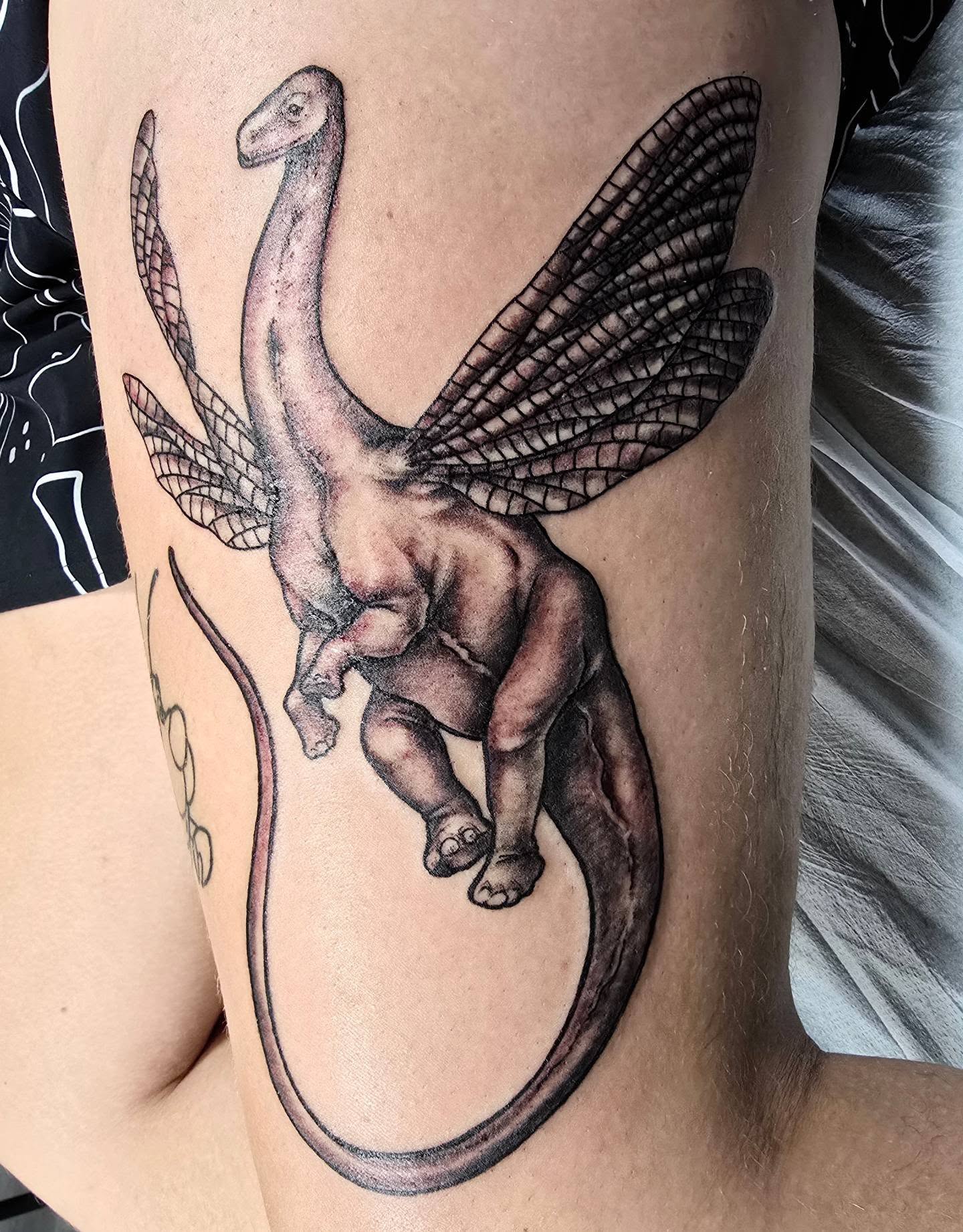 Dinosaur with wings realism tattoo on the thigh by bonnie