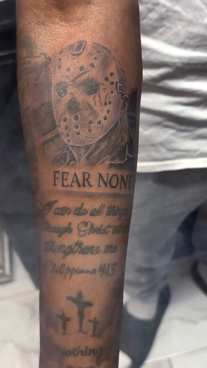 Jason Voorhees mask and scripture realism tattoo on the forearm by Jose Onasis Disla, New York, New York