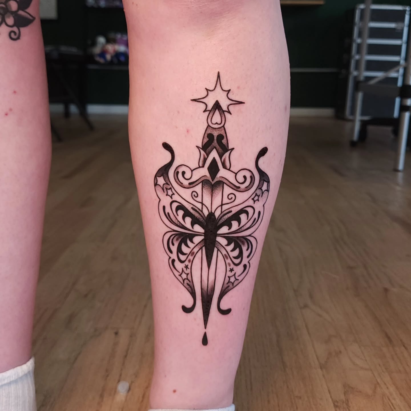 Ornamental dagger ornamental tattoo on the calf by Maxine Stewart