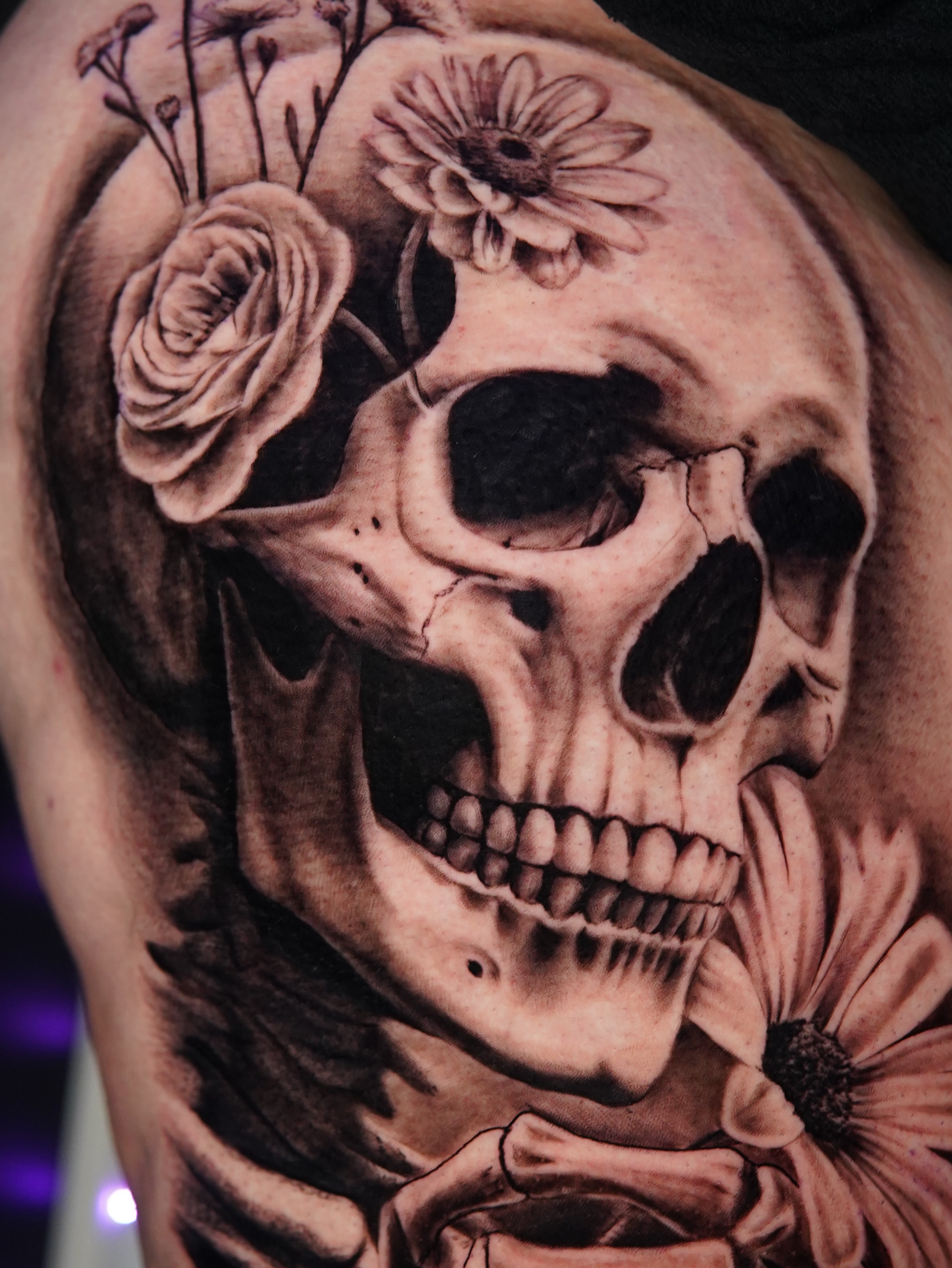 Skull with flowers realism tattoo on the shoulder by Marissa S., Lansing, Michigan