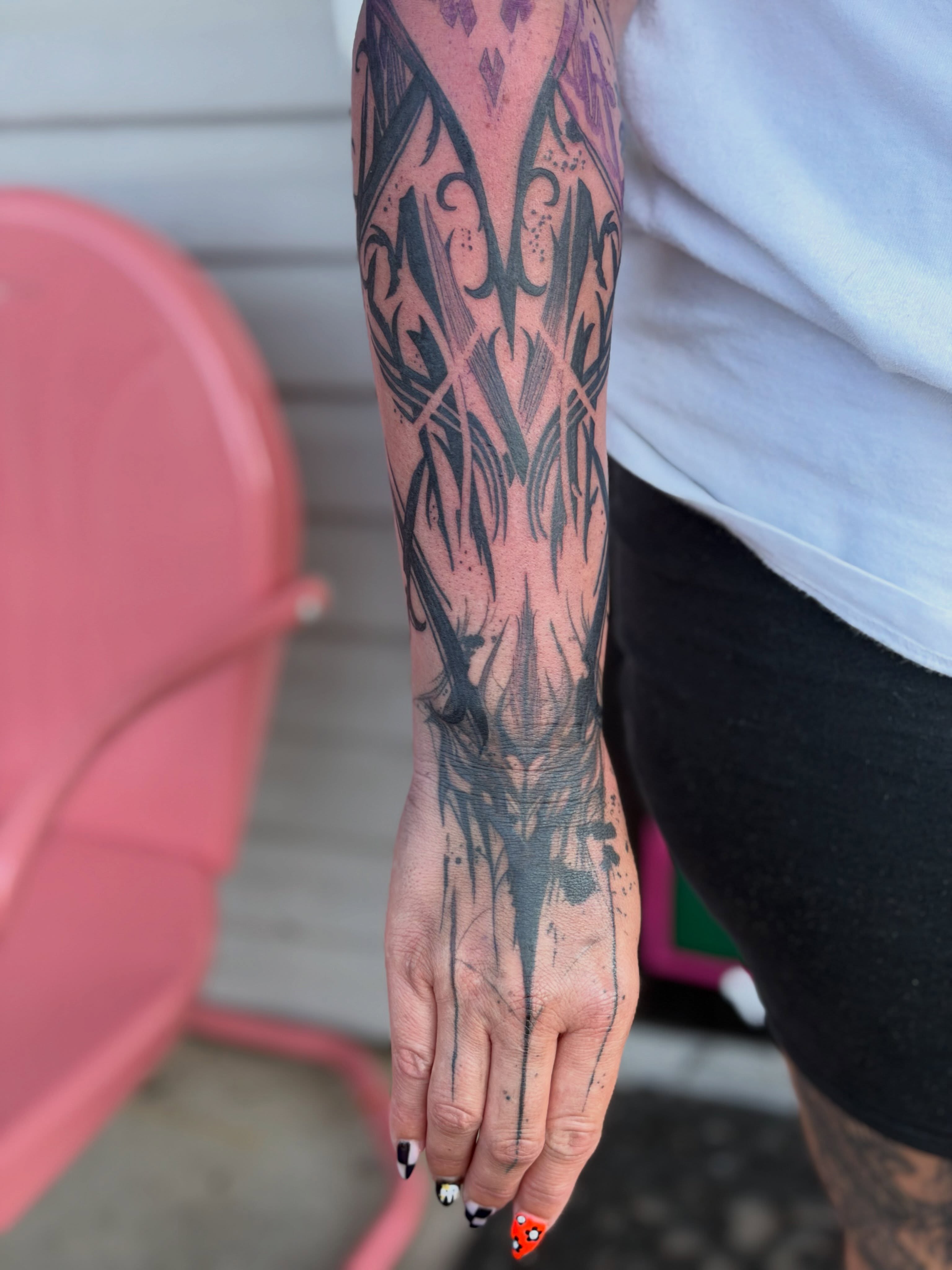 Abstract floral geometric tattoo on the forearm by Aura Noire