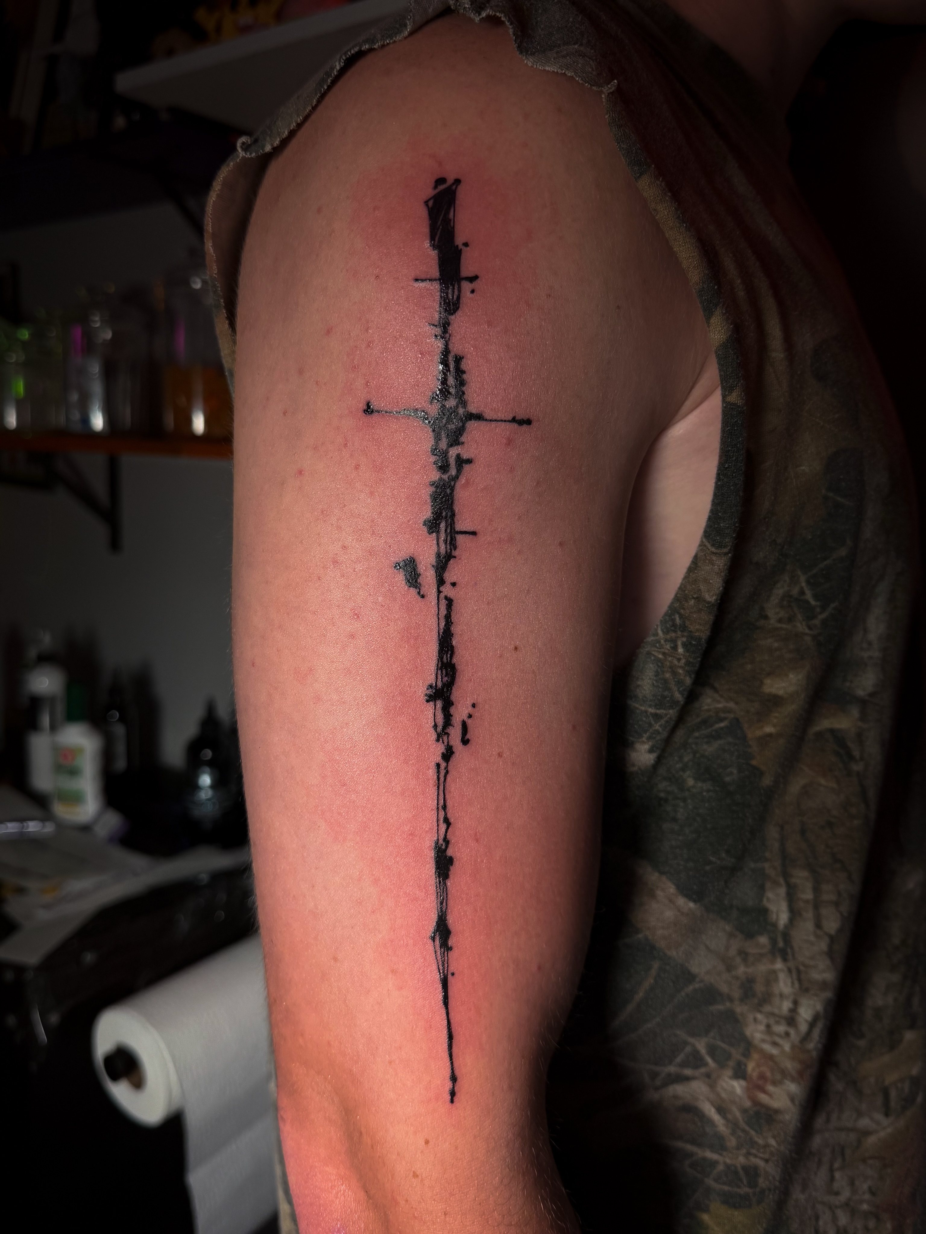 Cross black and grey tattoo on the upper arm by Tattoo Artist X Kamm, Salt Lake City, Utah