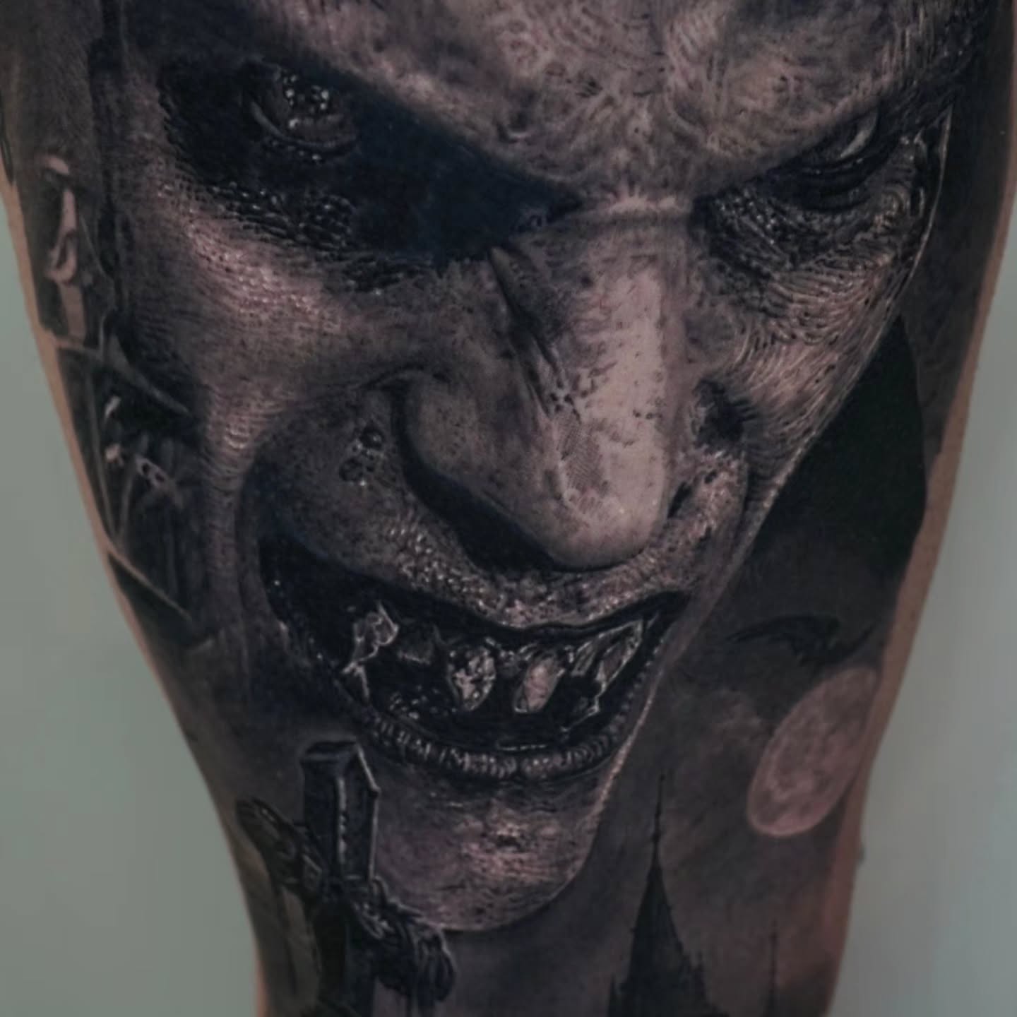 Demon face dark realism tattoo on the thigh by Owen Paulls