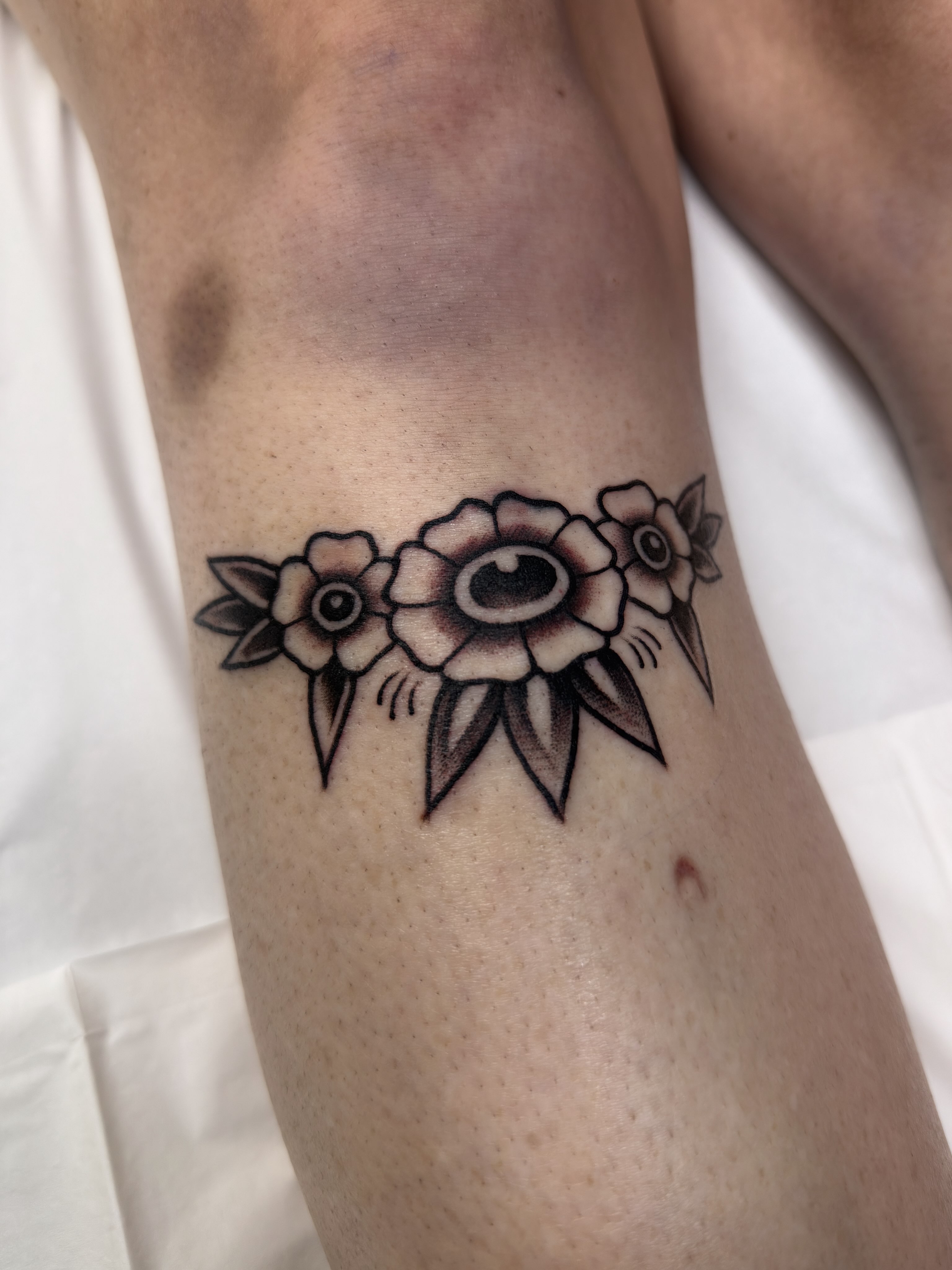 Flowers black and grey tattoo on the forearm by Trav, Bayville, New Jersey