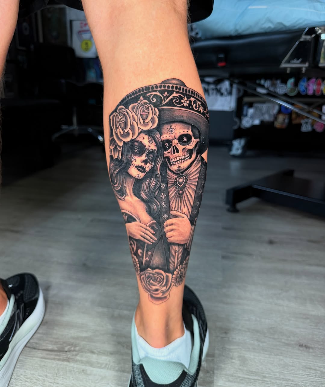 Sugar skull couple realism tattoo on the calf by Beau Zeis