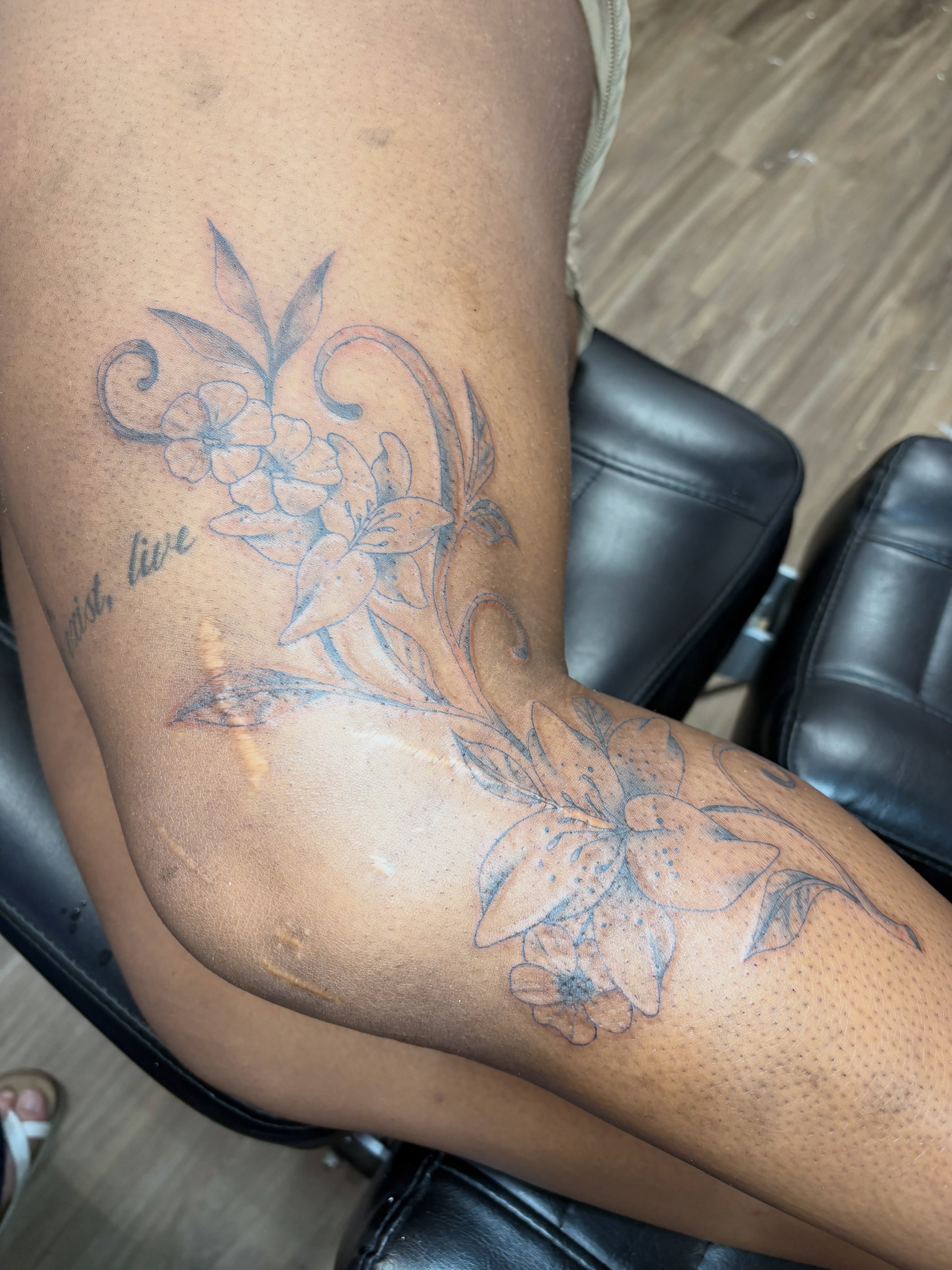 Floral design black and grey tattoo on the upper arm by Cincinnati Tattoo Artist