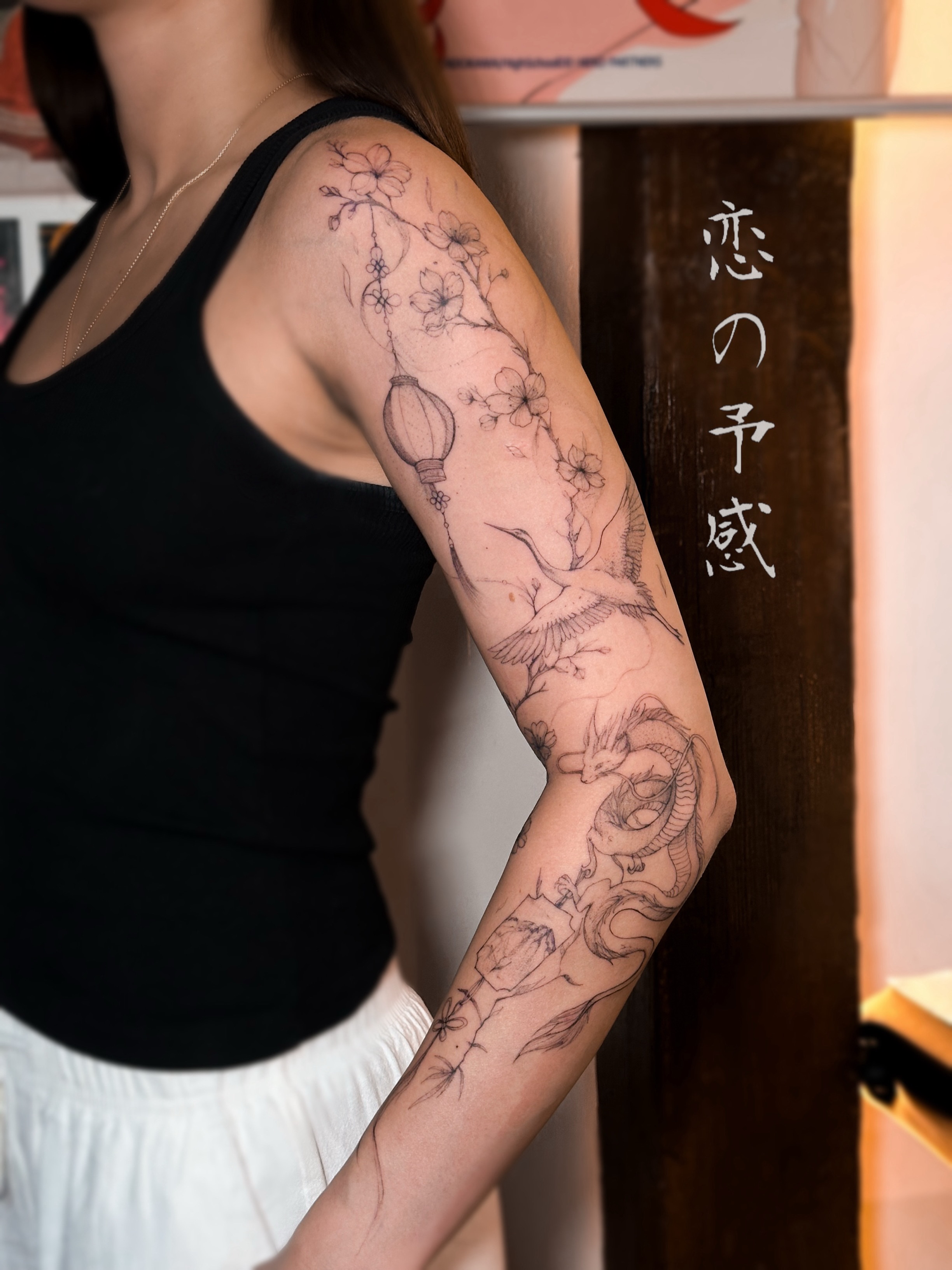 Cherry blossoms and lantern black and grey tattoo on the forearm by Mila, Riga, Latvia