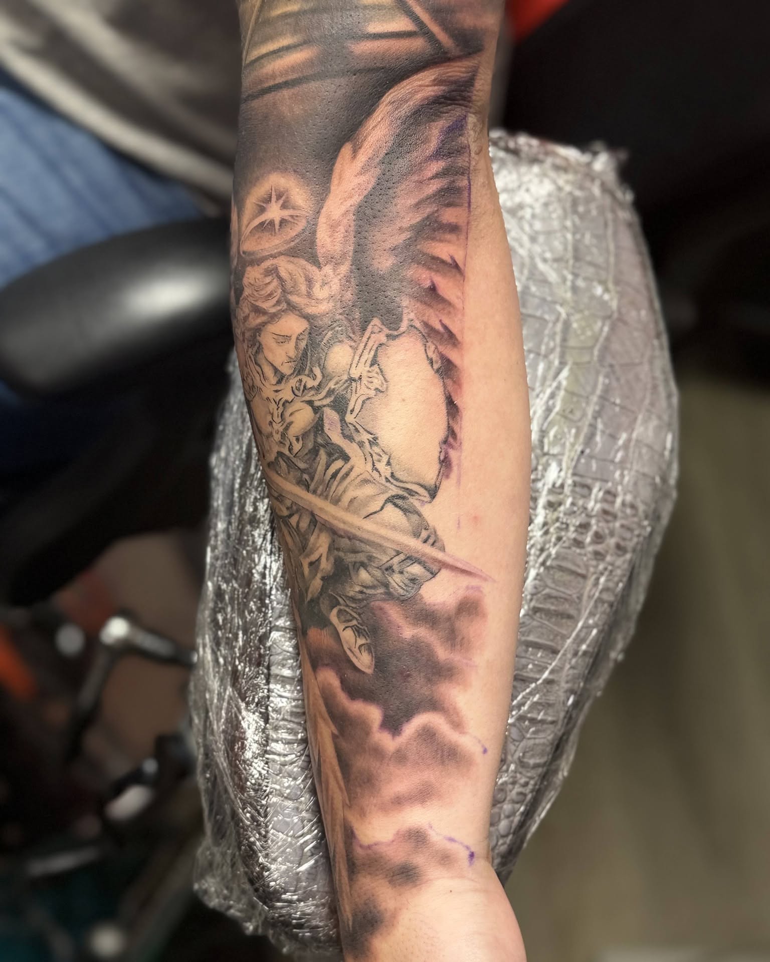 Angel with sword realism tattoo on the forearm by Gene Britton