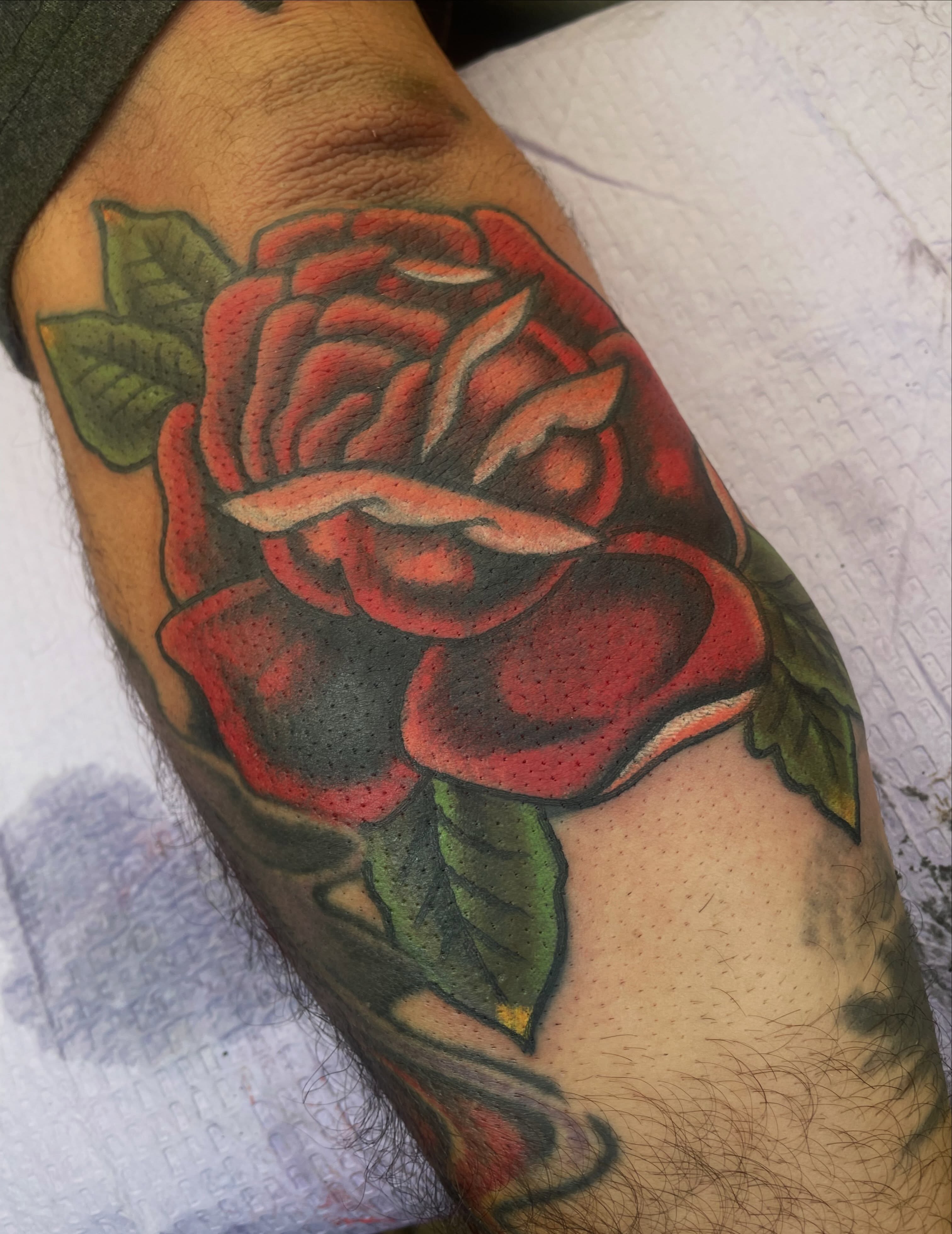 Red rose American traditional tattoo on the forearm by Francis Kane