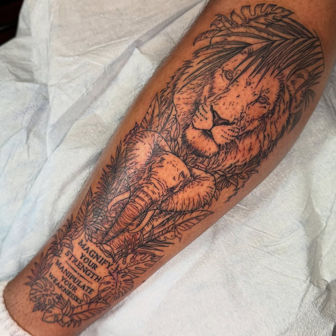 Lion and elephant black and grey tattoo on the forearm by Jack Hatchet Tattoos